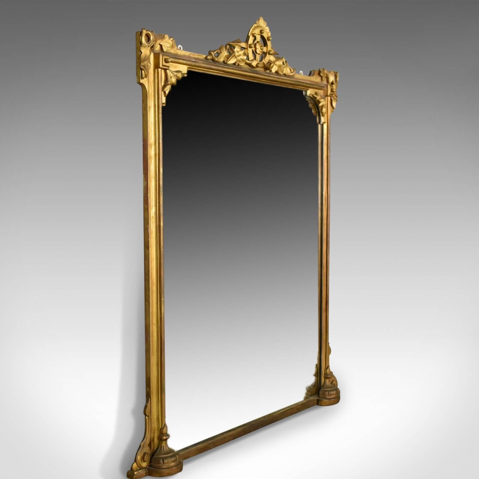 This is an antique overmantel mirror, an English, Victorian wall mirror in giltwood and gesso frame dating to circa 1850.

Attractive golden tones in the giltwood frame
A refined piece displaying nautical overtones
The crest a rosette in compass
