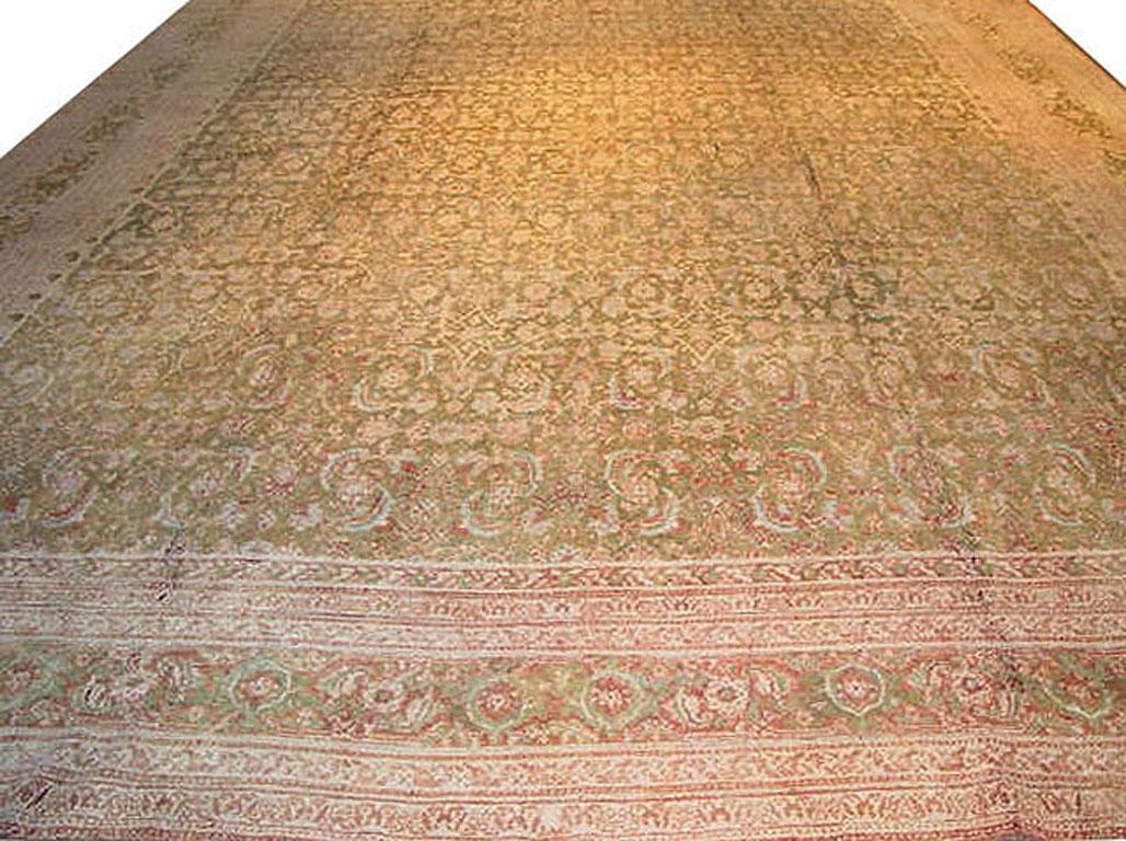 A rare example of an antique cotton Agra rug, finely woven. The soft green field filled to overflowing with flower heads is testament to the skill of the weavers to create this masterpiece. During much of the history of the Mongol Empire, Agra was