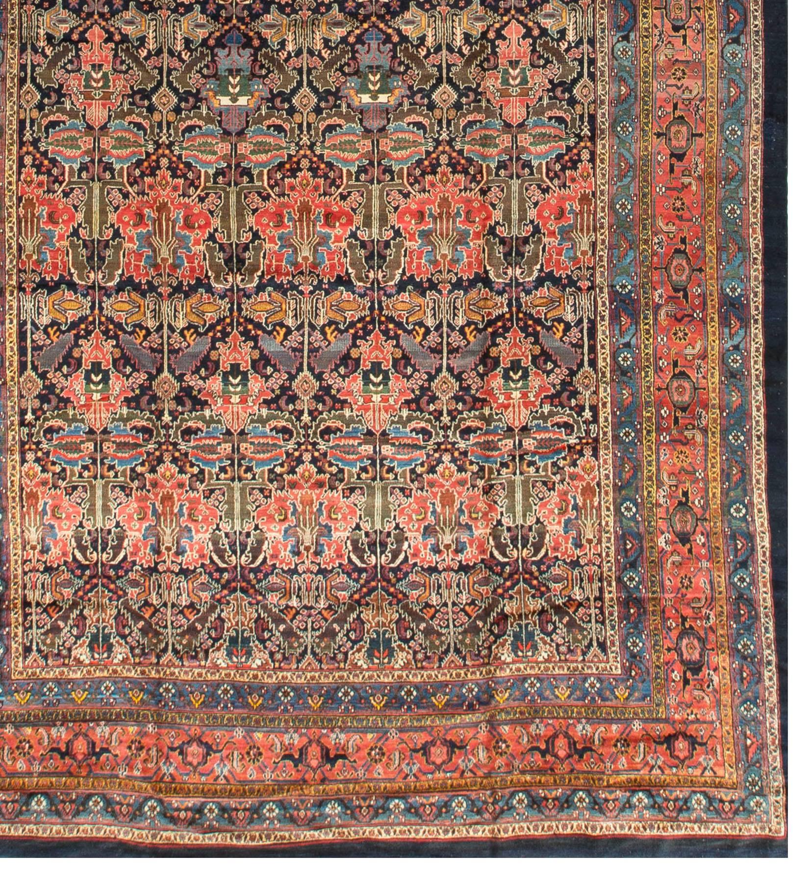 Antique Persian Bakhtiari rug, circa 1890. A wonderful antique Persian Bakhtiari handwoven rug. The deep navy ground field bursting with floral themed shapes that give a central strength to the overall design. The beautiful main triple borders each
