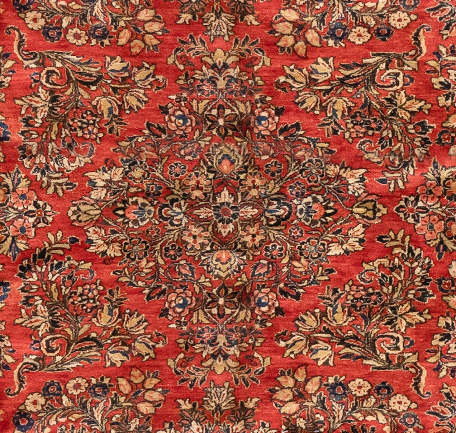 Sarouk is a small village and its neighboring villages in Northwestern Iran. Most Sarouk carpets follow a very distinctive design and is depended on floral sprays and bouquets. 

This is a fine example of an oversize antique Sarouk carpet dating