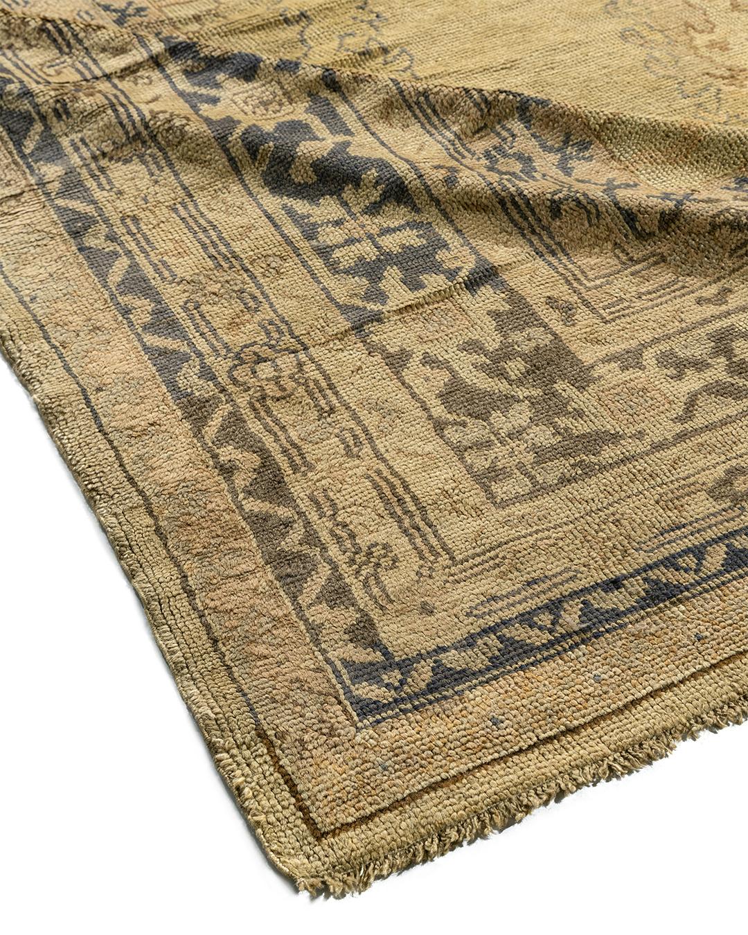 Antique Oushaks are known for their soft palettes combined with eccentric drawing. The relatively coarse weaves, here on a wool foundation, mean vinery and branches are bent and broken rather than flowing smoothly, and individual motives develop