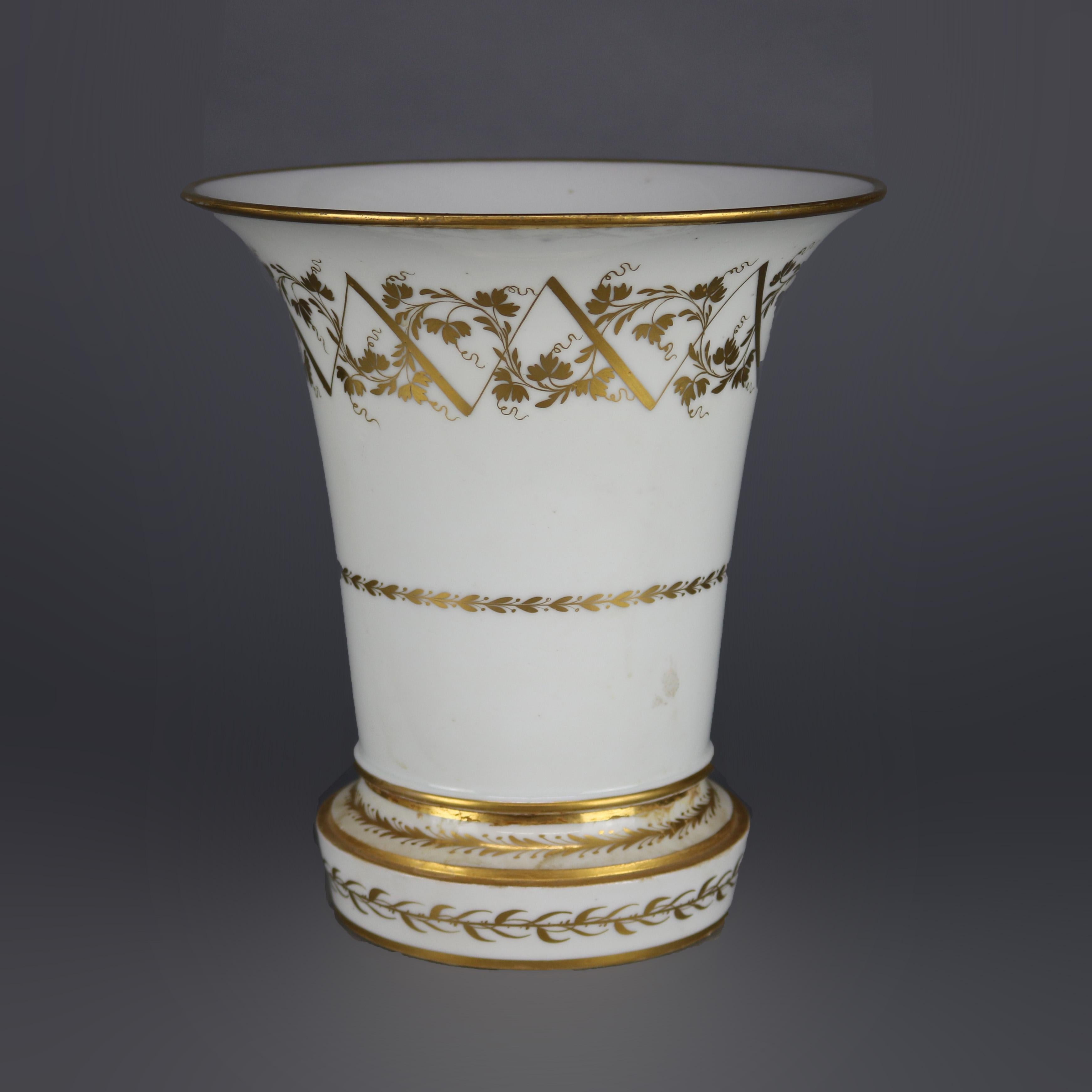 An antique oversized Neoclassical porcelain garniture set offers paint and gilt decorated Austrian Royal Vienna central urn with reticulated lid and raised on three convex legs, beehive maker mark on base as photographed; flanking gilt decorated