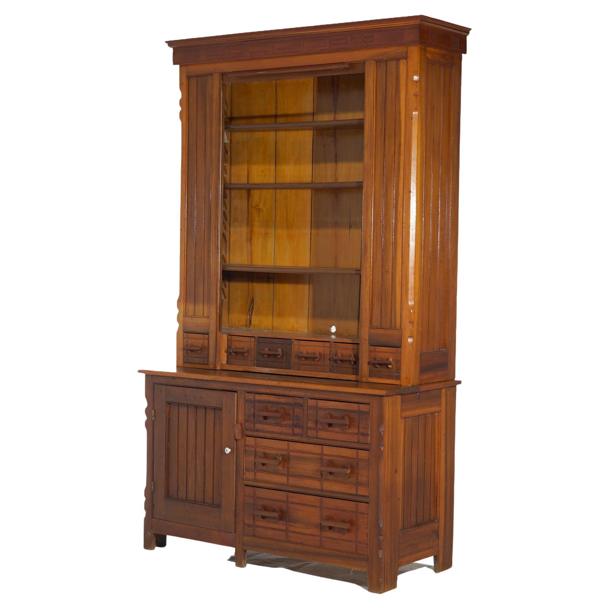 An antique oversized country store cabinet offers upper tambour roll-top case opening to shelved interior over lower case with drawers and cabinet, circa 1900

Measures - 87.25