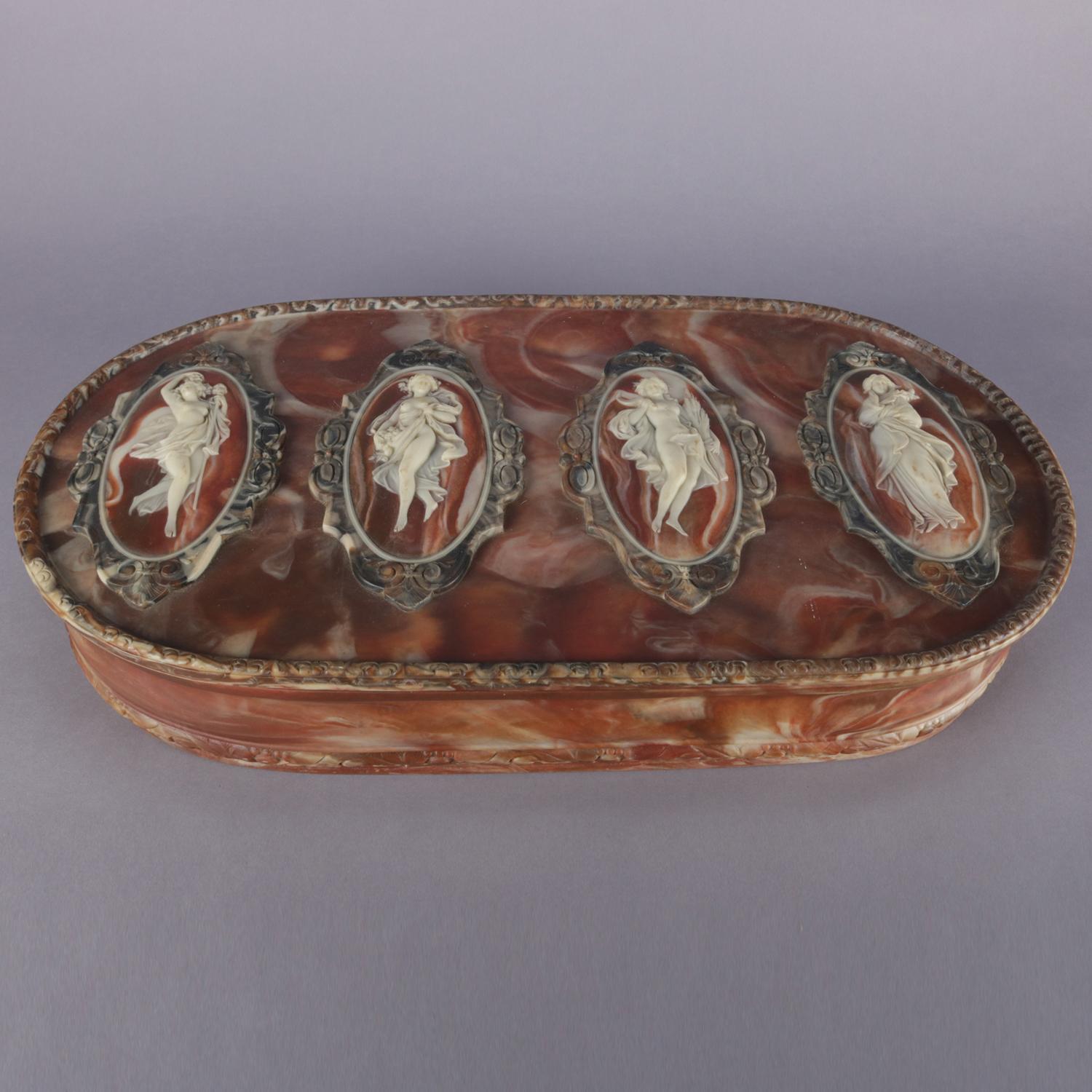 Antique oversized jewelry box features hand-carved incolay stone construction with four reserves with full length portrait cameos of Classical women, interior is lined with velveteen and has two moon form trays jewelry, original 