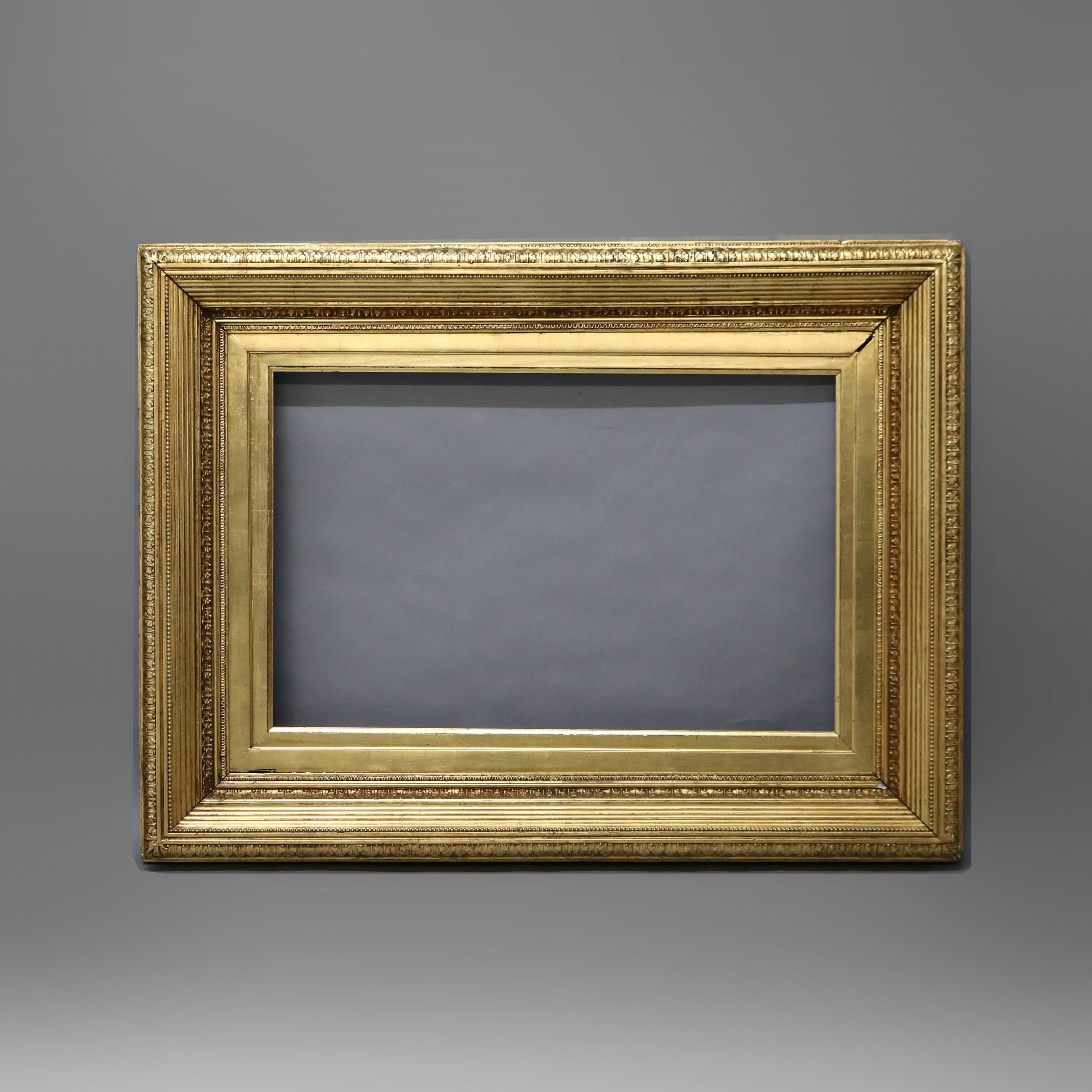 An antique and large museum artwork or painting frame offers giltwood construction with reeded, bead, and foliate elements, c1890

Measures- Overall 36.75''h x 48.75''w x 5''d; Sight 21.25