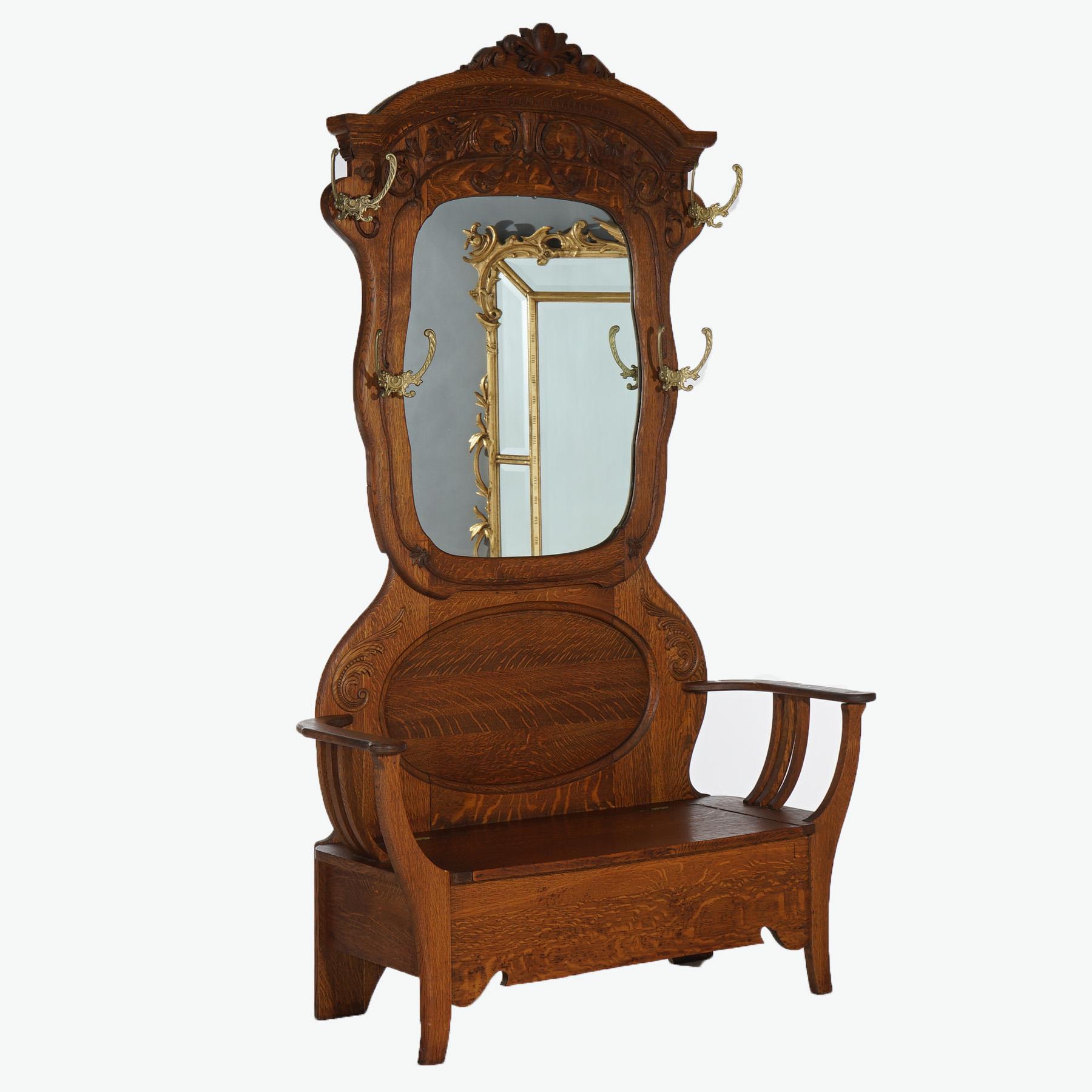 A large R J Horner hall seat offers quarter sawn oak construction with foliate carved crest over shaped mirror, seat with lift top, circa 1900
 
Measures - 79