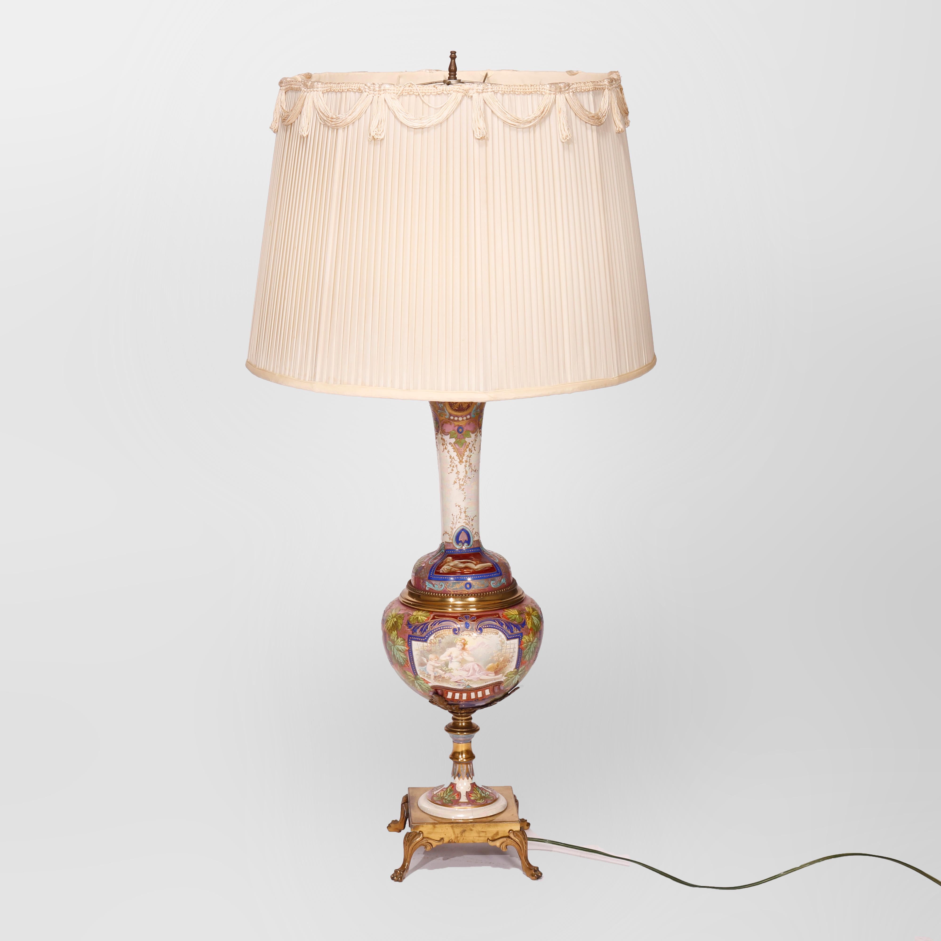 An antique and large Royal Vienna double socket table lamp offers porcelain urn with hand painted panels of Classical women and cherubs, gilt highlights throughout, raised on cast footed base, c1880

Measures: Lamp 41.25''H X 8''W X 8''D; shade