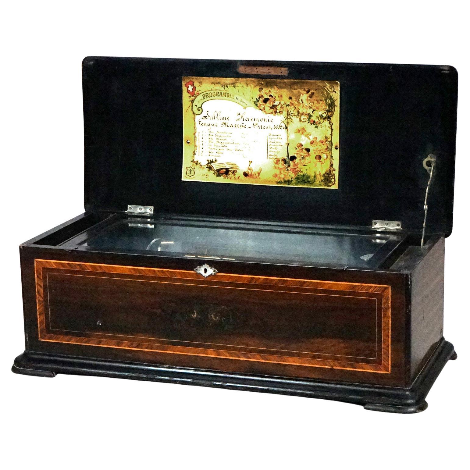 Boîte à musique suisse ancienne à douze dents, incrustation de bois de rose et de nacre, vers