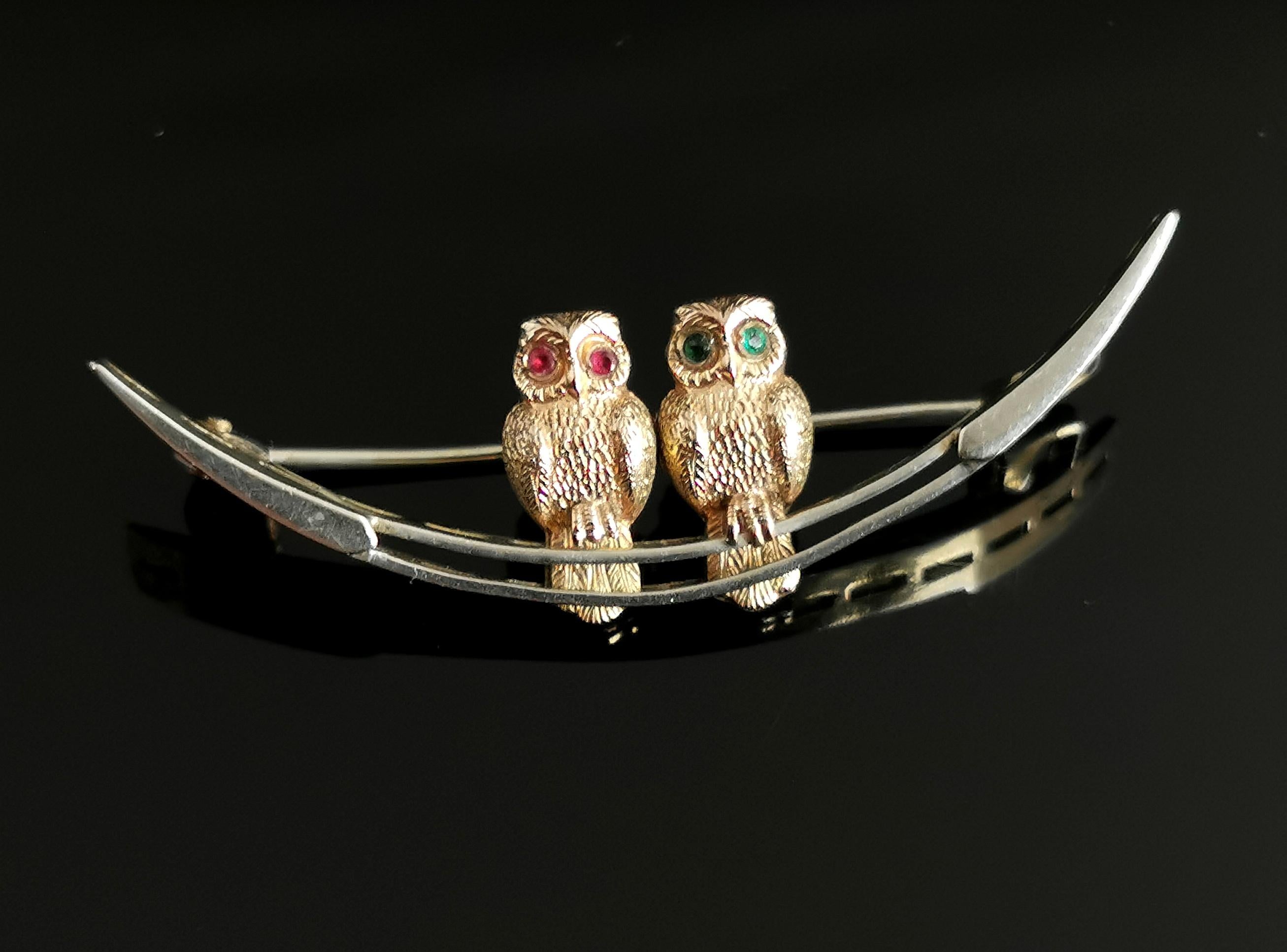 A superb antique Edwardian era, silver, gold and paste crescent brooch.

A beautiful piece it features two owls sitting on top of an open silver crescent moon.

The owls are finished with an applied 9kt gold front and both have paste stone eyes in