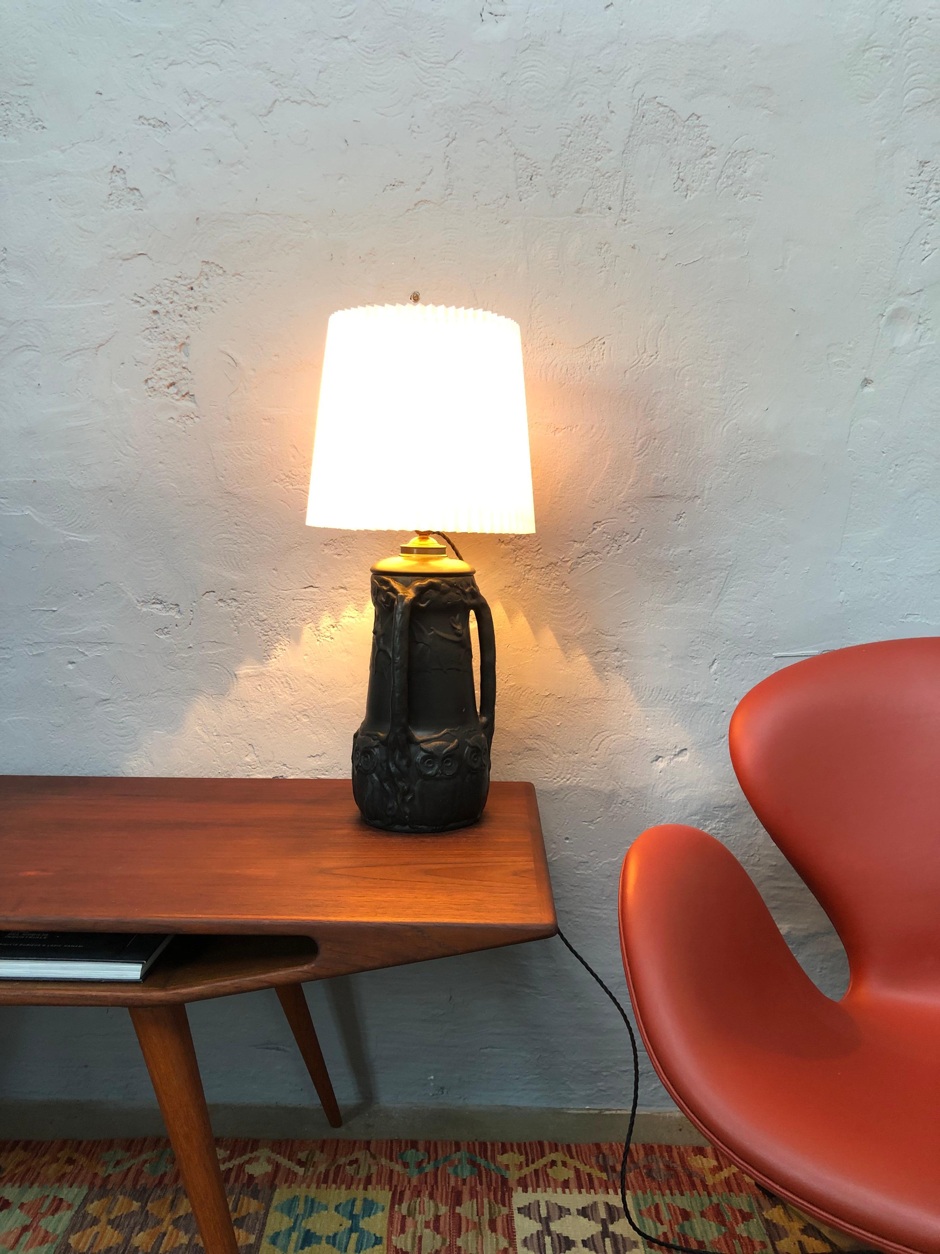 An amazing iconic black pottery table lamp with owls and bats by Lauritz Adolph Hjorth of Bornholm Denmark. 
The lamp has been rewired with a black twisted cloth flex and grounded. 
Still maintains its original brass and ceramic bulb holder with