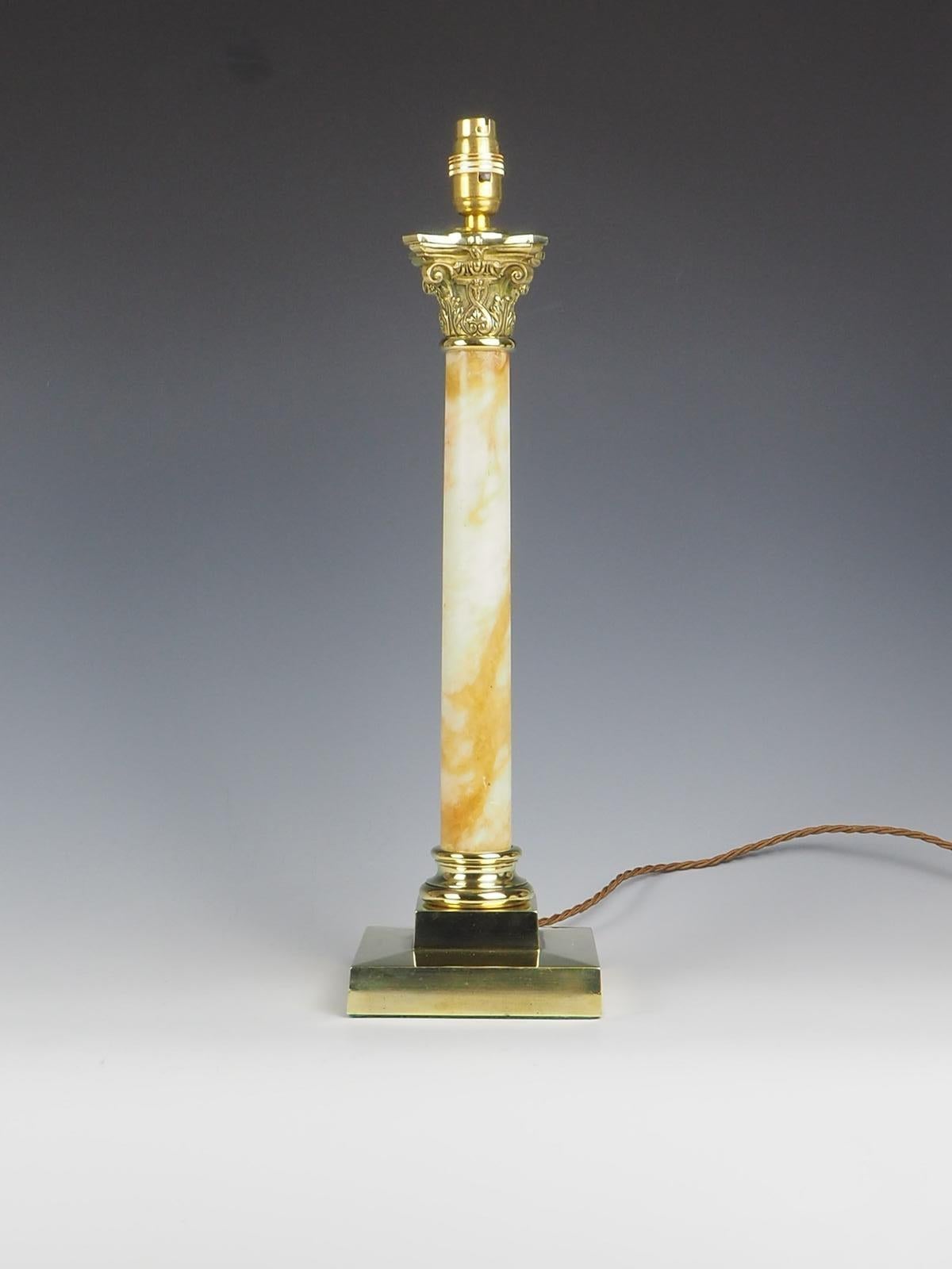 Antique Oynx and Brass Corinthian Table Lamp is a truly remarkable piece that exudes elegance and sophistication.

With its very large size and exceptional quality, it is sure to make a statement.

The lamp features a stunning Oynx shaft that leads