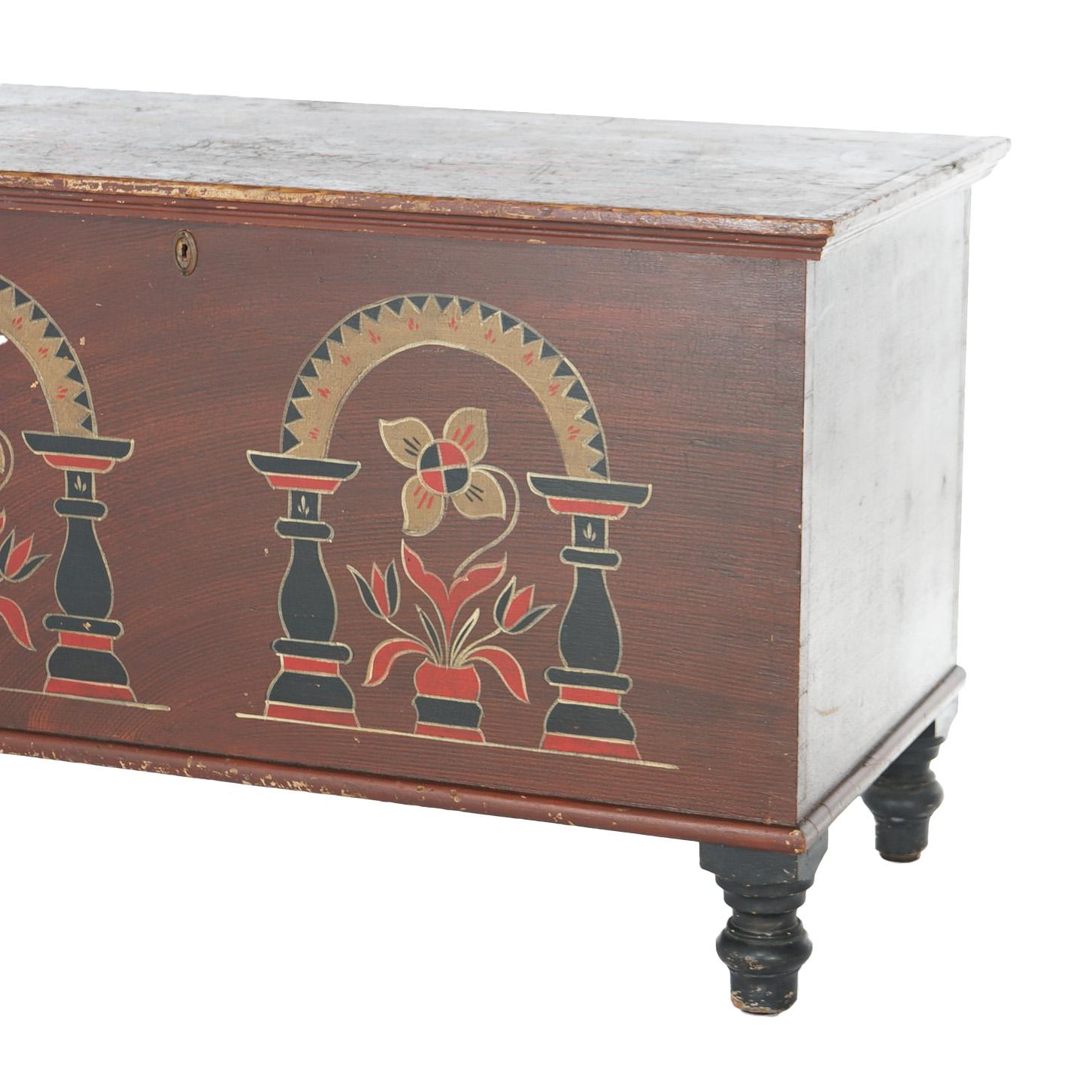 An antique Pennsylvania German Dutch Lancaster County blanket chest offers poplar and pine dovetailed construction with grain painted finish having hand painted stylized floral decoration; lift top opens to interior with full patch box; raised on