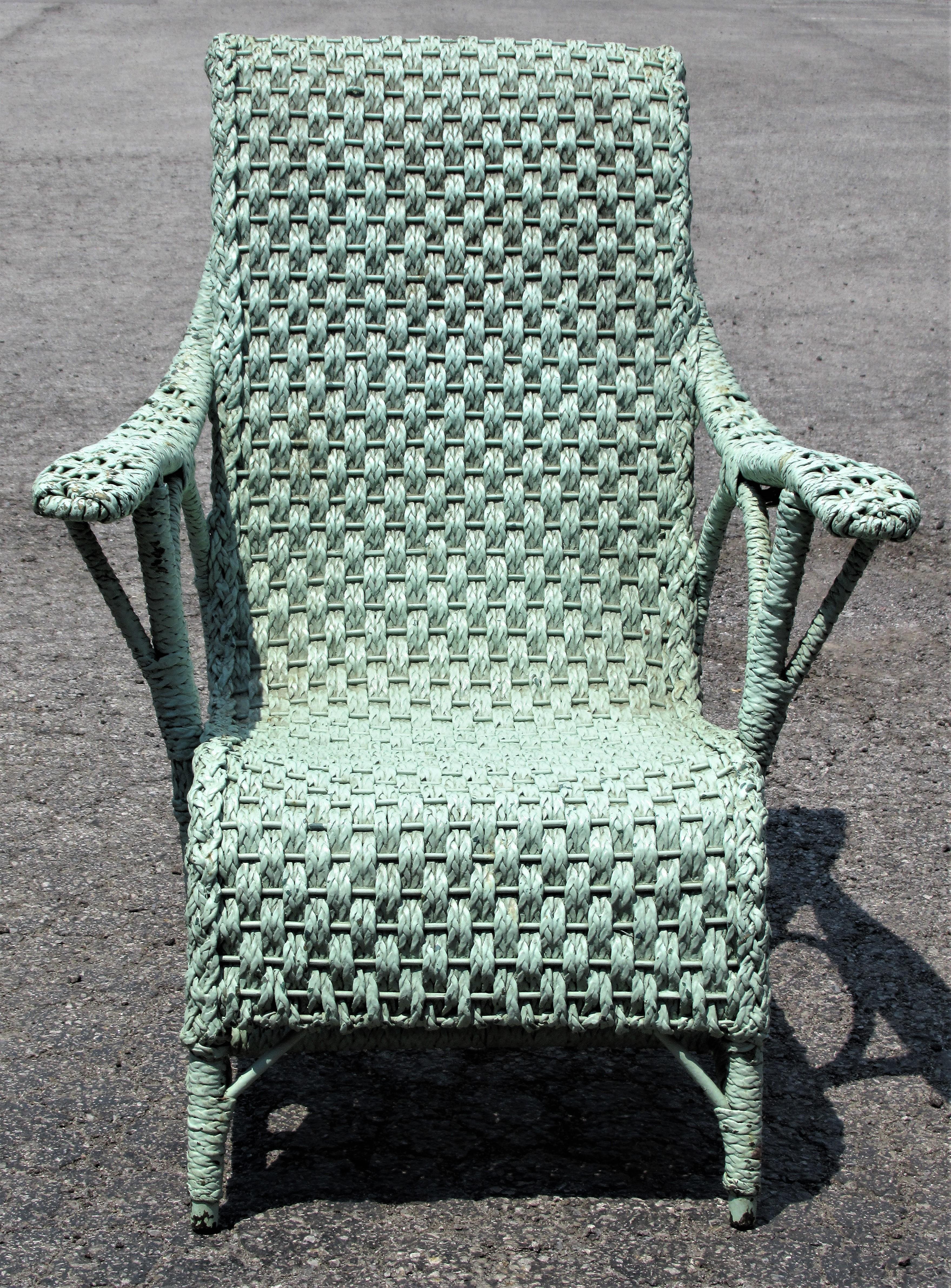 Large scale tall scroll back curved paddle arm woven wicker lounge chair in perfectly aged old sea foam green painted surface. A rare chair with an exceptionally beautiful sculptural form. Dates from the early 1900s. Look at all pictures and read