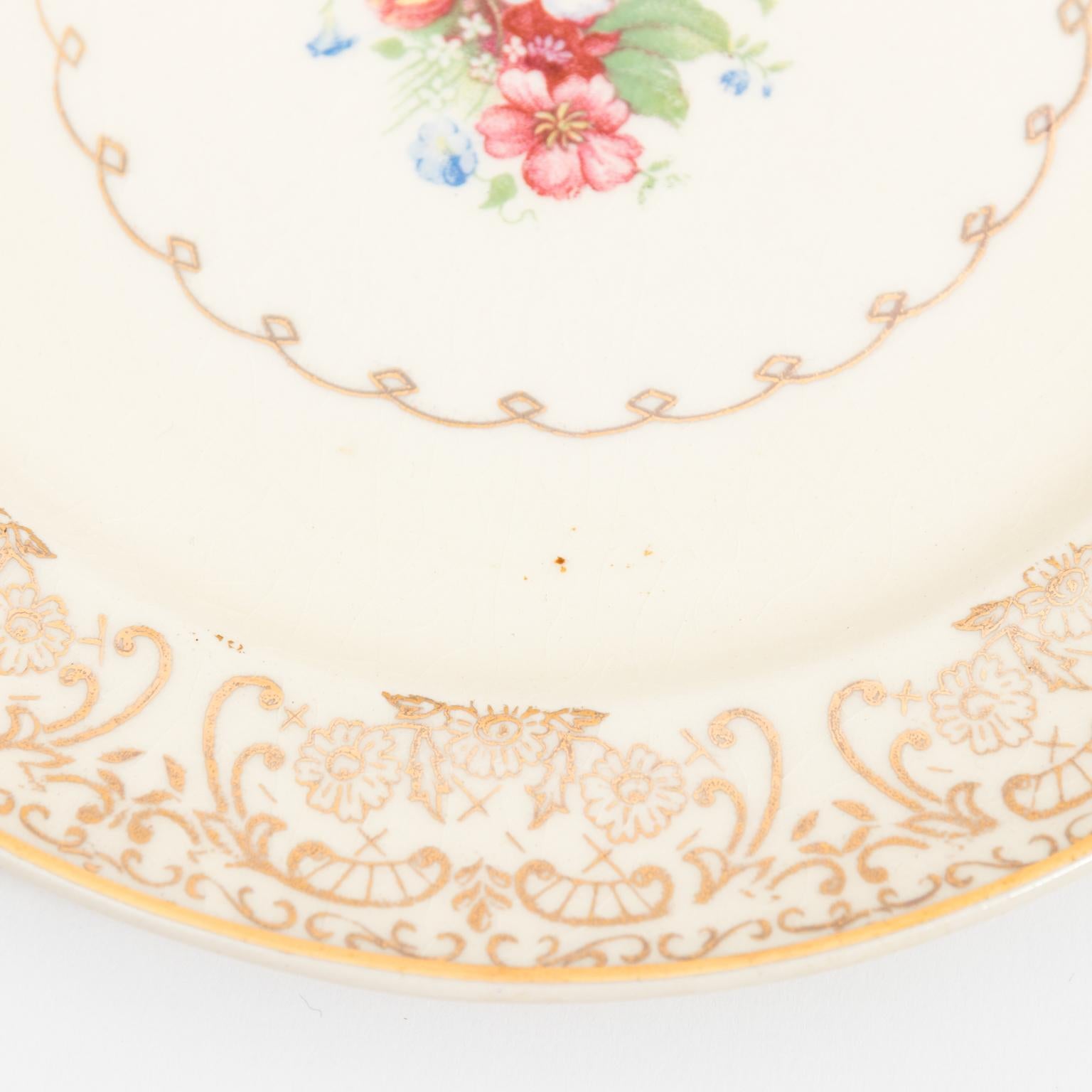 Set of floral Paden city pottery company dinnerware consisting of: plates, soup bowls, bread and butter plates, dessert bowls, three serving bowls, two oval platters and a gravy boat, circa 20th century. Set made in Paden City, West Virgina.
