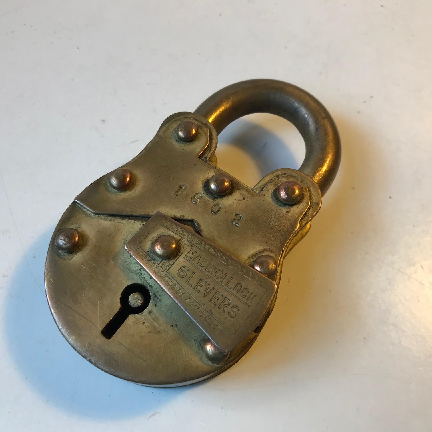 Beautifully patinated padlock with 6 levers. It comes with two keys and is imprinted Nadeem Lock, number 1802. It is fashioned entirely out of brass.