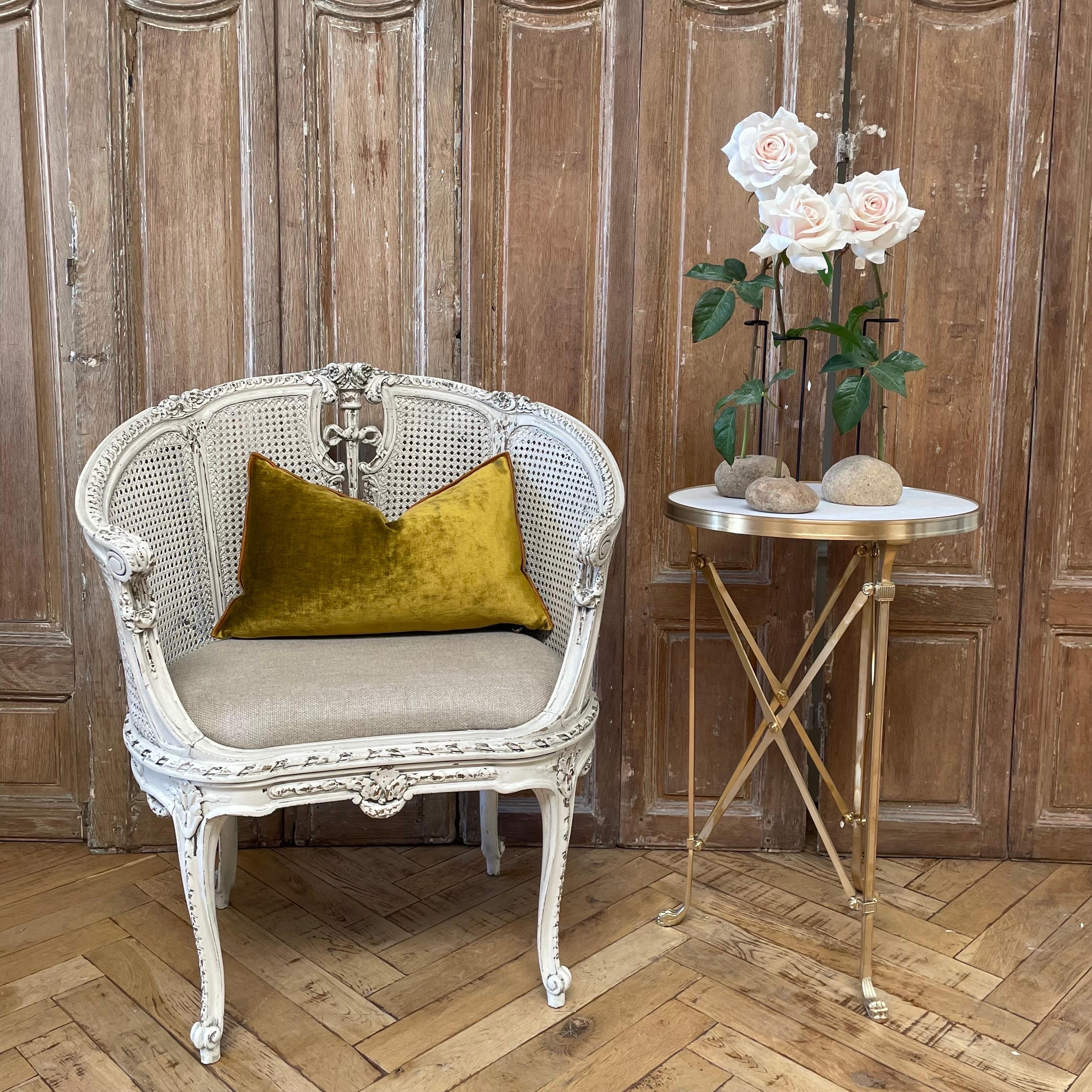 Painted and upholstered seat, Louis XV Style barrel chair with subtle distressed edges, and antique patina. 
Hand carved roses, and original cane back.  Small flaws to cane, does not distract or hurt the integrity of the chair.
Solid and sturdy