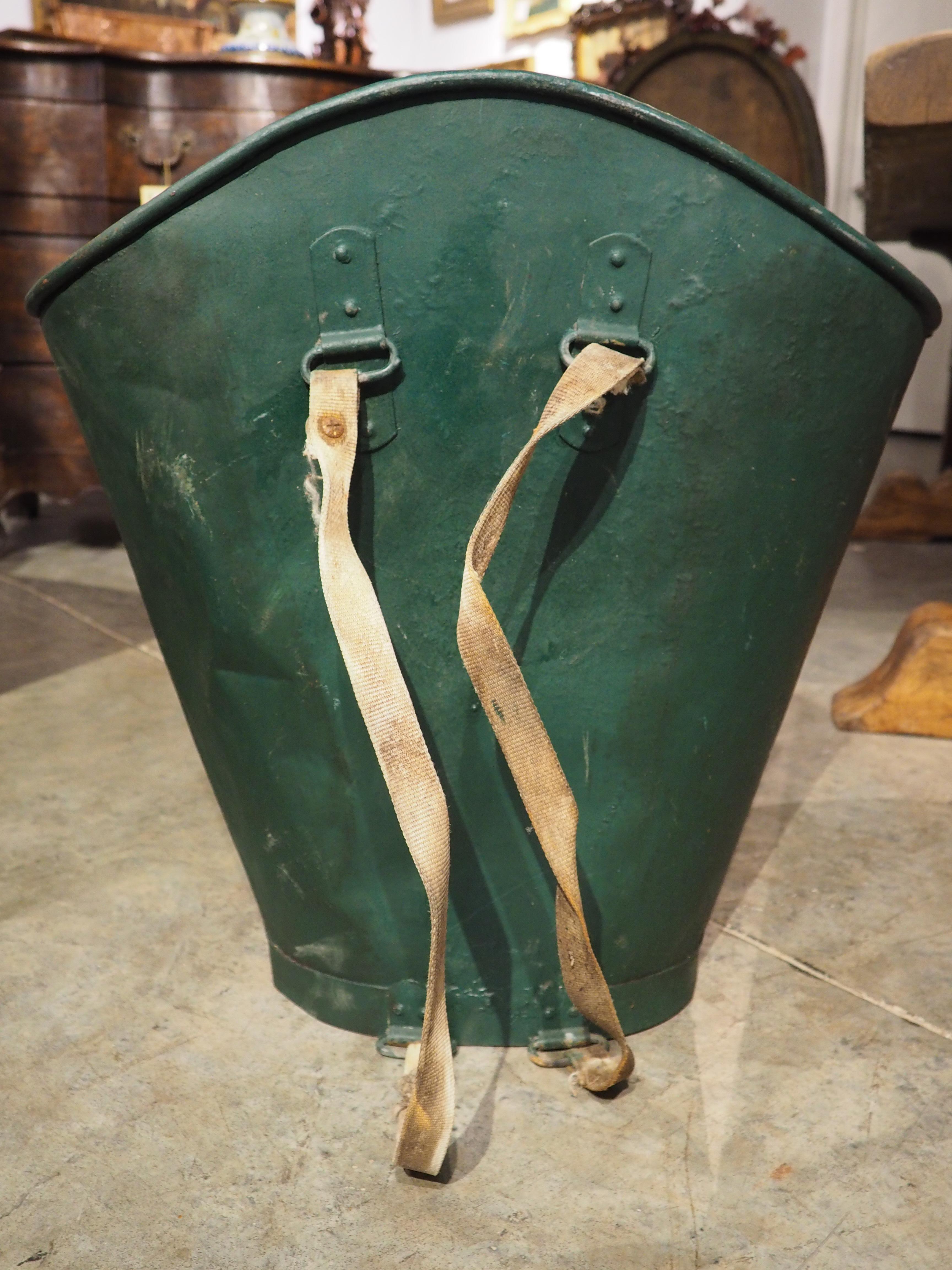 This French metal container is known as an hotte. Hottes were used during the 19th and early 20th centuries for collecting grapes in vineyards. The vineyard employee would attach the hotte to his/her back and place the harvested grapes directly into