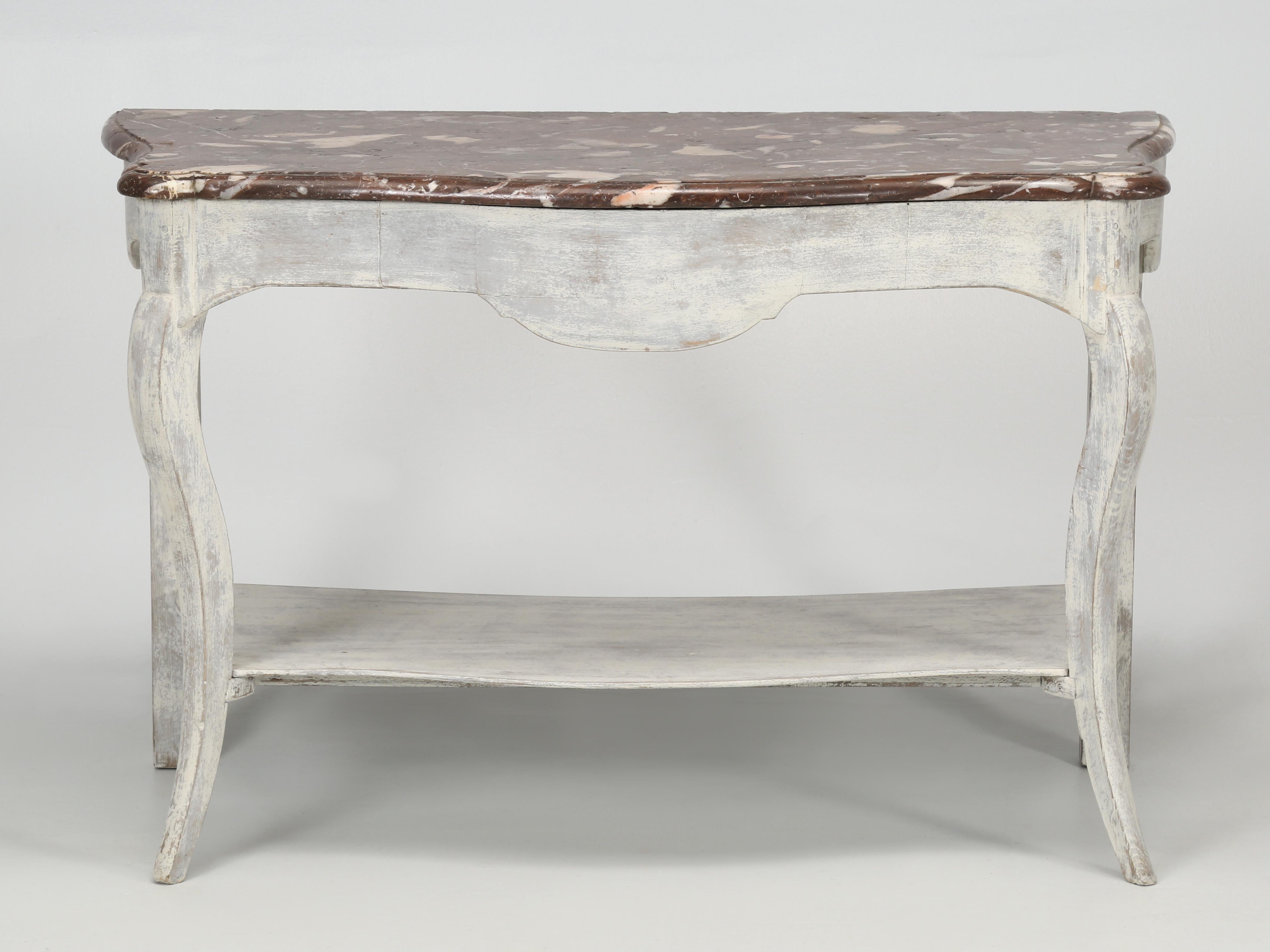 Antique marble console table that was recently sourced from an antique dealer who closed up, so our knowledge is limited as to its originality. What we know for sure, is that the marble top is extremely old and has an incredible patina. There are no