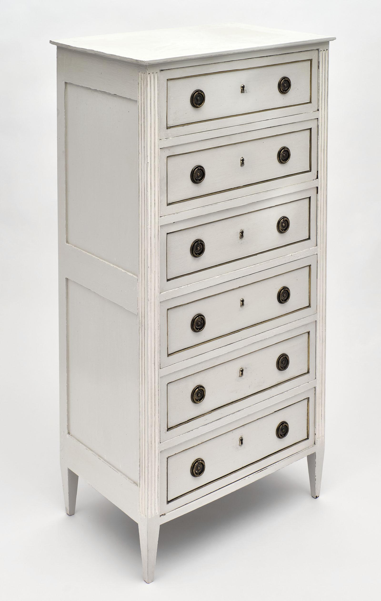 French antique painted semainier in the Louis XVI style. The word “semaine” means week in French, and these cabinets are named for one drawer per day of the week. The hand-painted Trianon gray color combines with white painted accents in the fluting