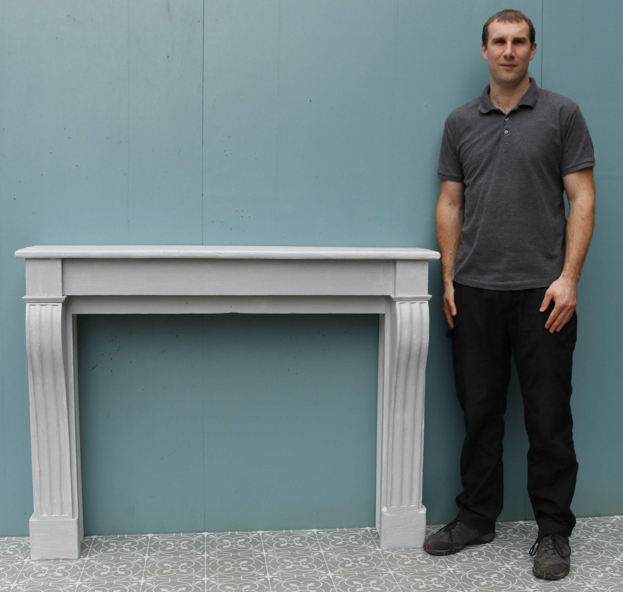 A rustic, French fire mantel in the Louis XVI style.
 
Additional dimensions 
Opening height 83 cm
Opening width 103.5 cm
Width across the foot-blocks 135.5 cm.