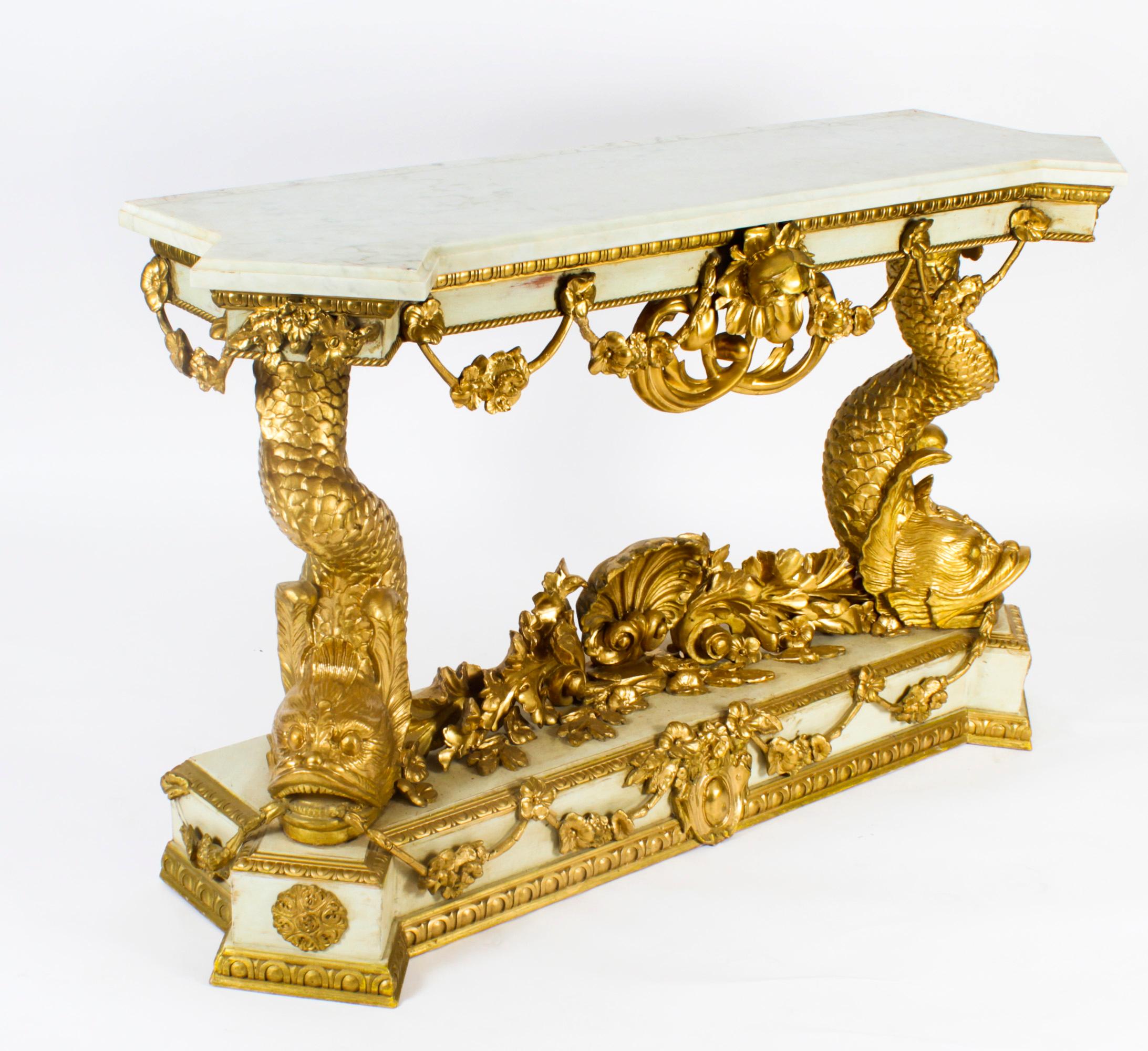 This is a beautiful Italian antique carved gilded and painted dolphin console pier table, in the Rocco manner, circa 1890 in date.
 
This fine quality console has a shaped carrara marble top on a green and gilded base with hand carved dolphins at