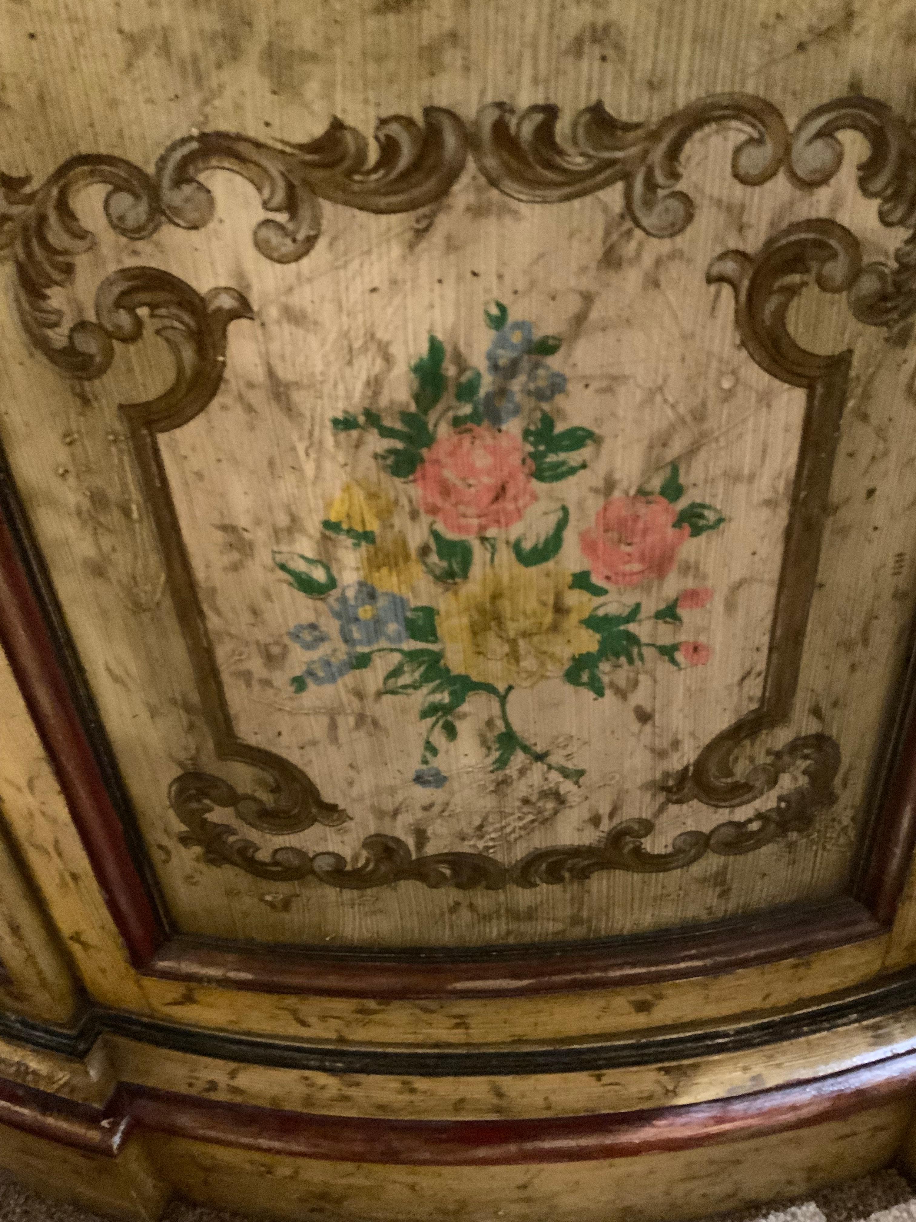 The hand painting on this piece is very well done in hues
Of gold, green and multi colors in the floral combination.
The sides are canted and the sides are also beautifully 
Adorned; the top is a walnut finish. It has one door in the
Center opening