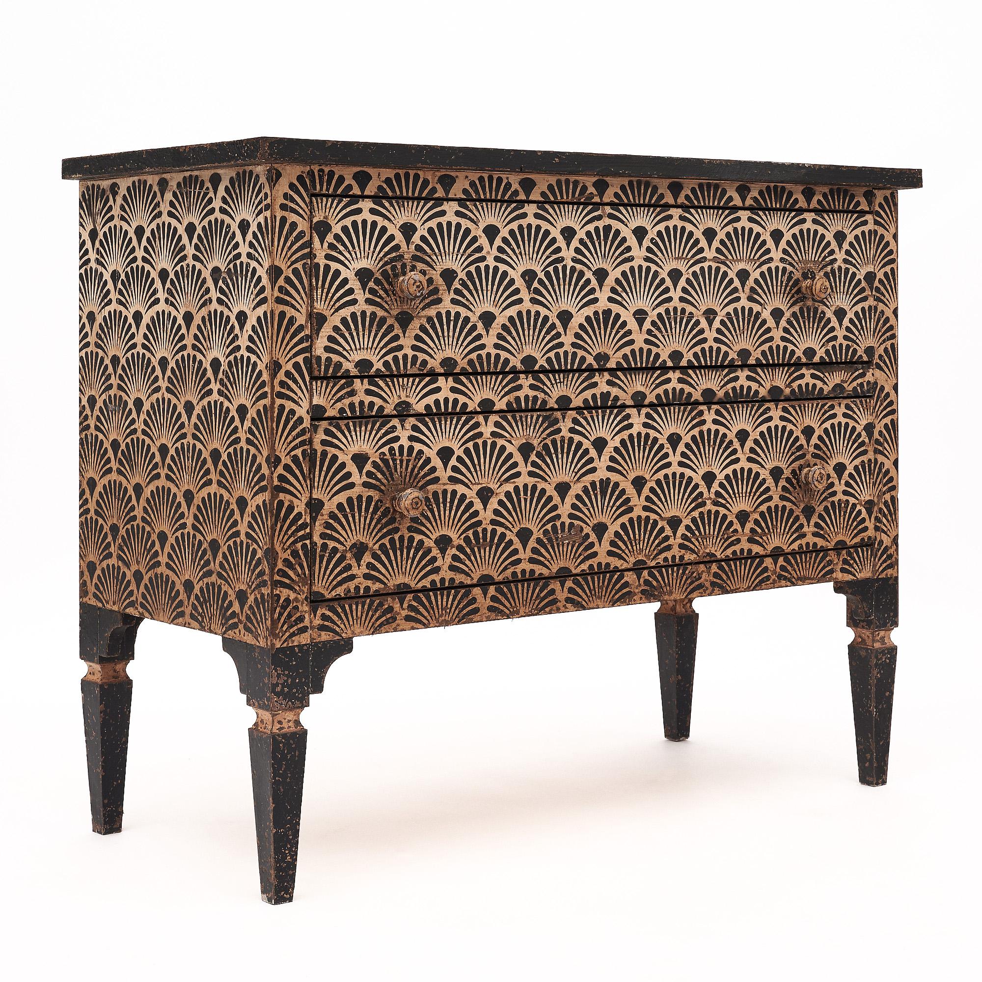 Pair of chests from Italy that feature a striking hand-painted design in cream and black tones showcasing a scalloped design. The chests are supported by four tapered legs and have two dovetailed drawers each.