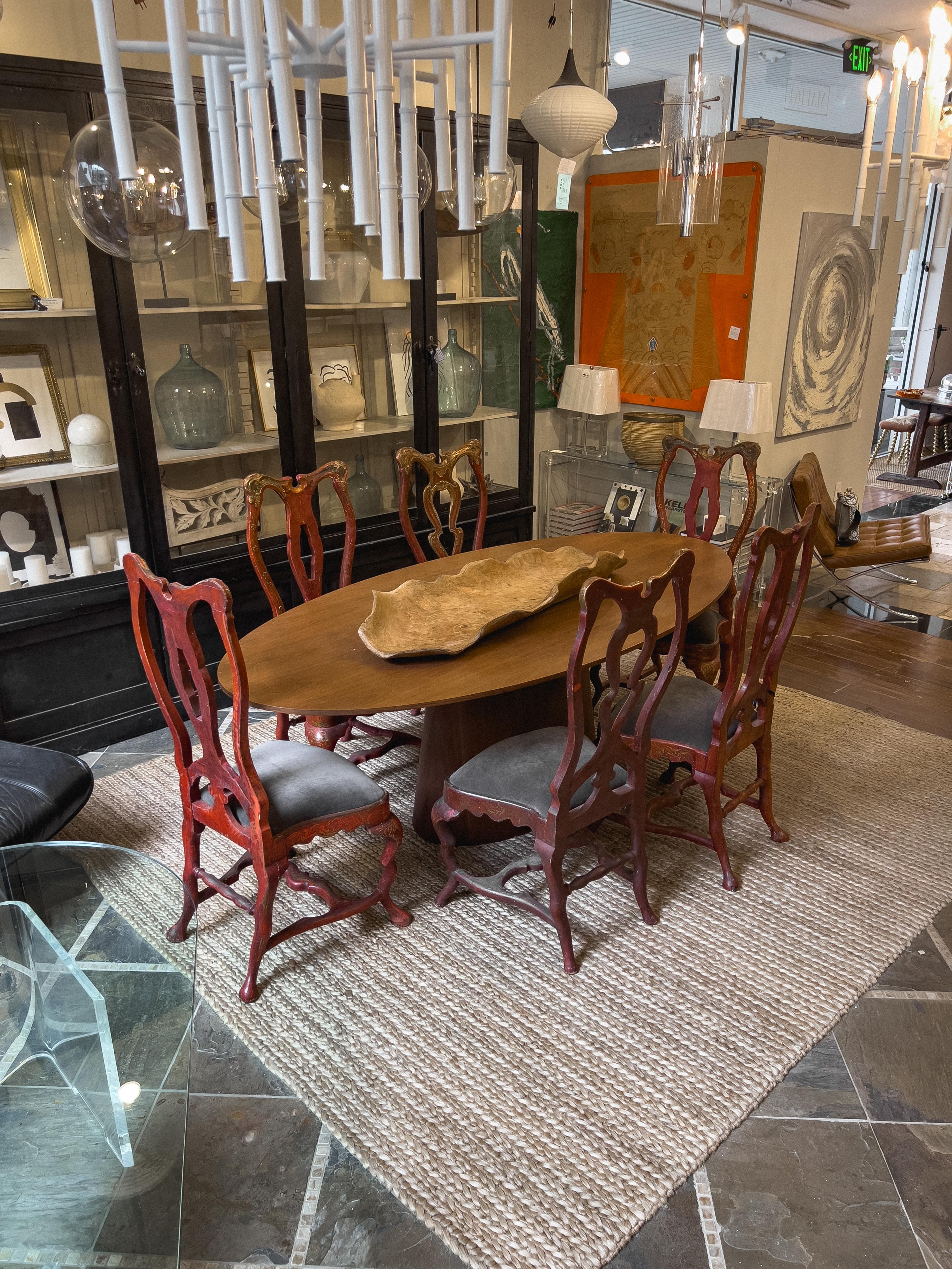 Antique painted Italian side chairs with foliate carved top rail supported by a shaped and pierced central splat, flanked by profoundly curved uprights. The whole back resting on an arched section with central carved support. The front and rear legs