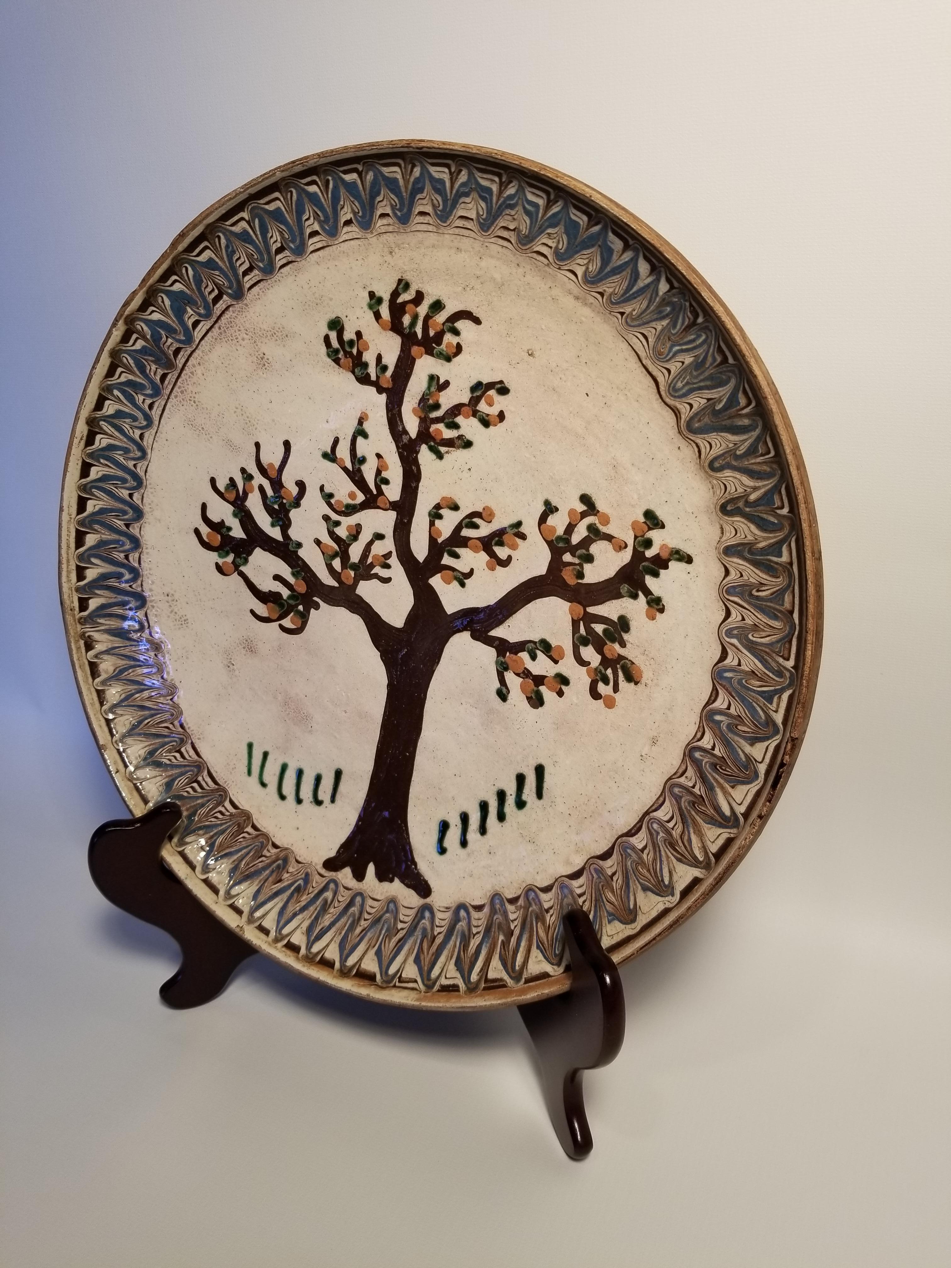 Charming folk art plate with a painted tree, American, early 20th century.