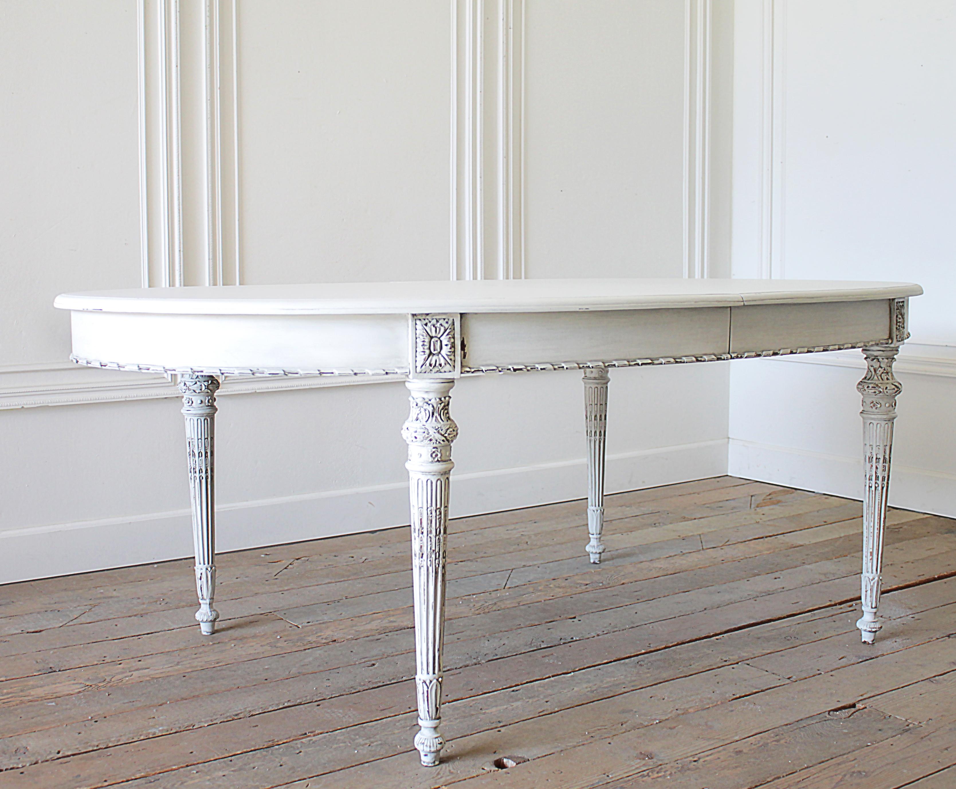 Antique painted Louis XVI style dining table with leaves
Painted in our oyster white finish, with subtle distressed edges, and soft antique glazed patina. Color is white, with a light grayish hue from the glaze, overall table is white. The table