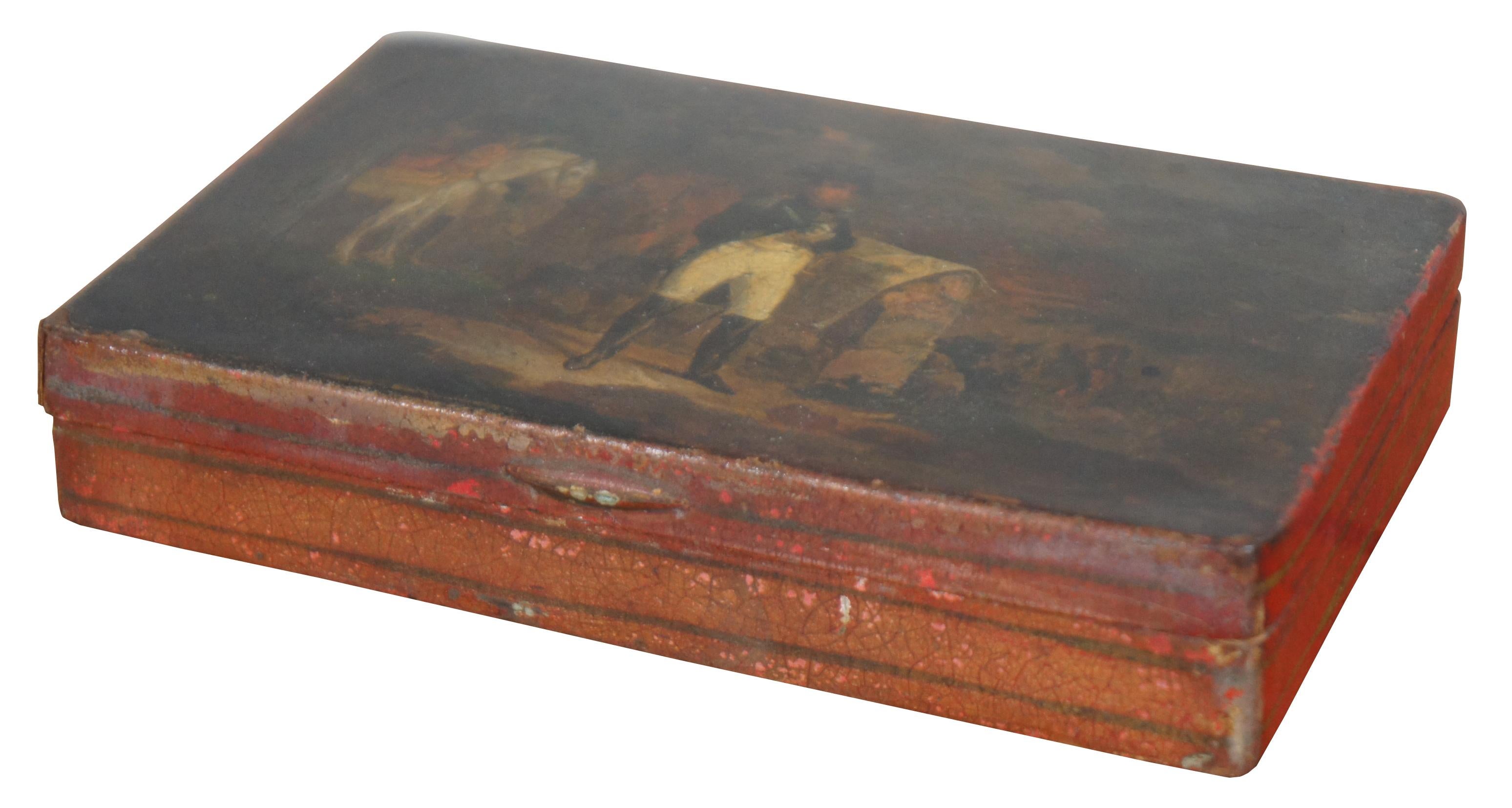 Rare antique metal tin tobacco cigar or cigarette box painted in red with an intricate scene on the lid of Napoleon Bonaparte surveying a map, with a white horse and soldiers at the ready.
