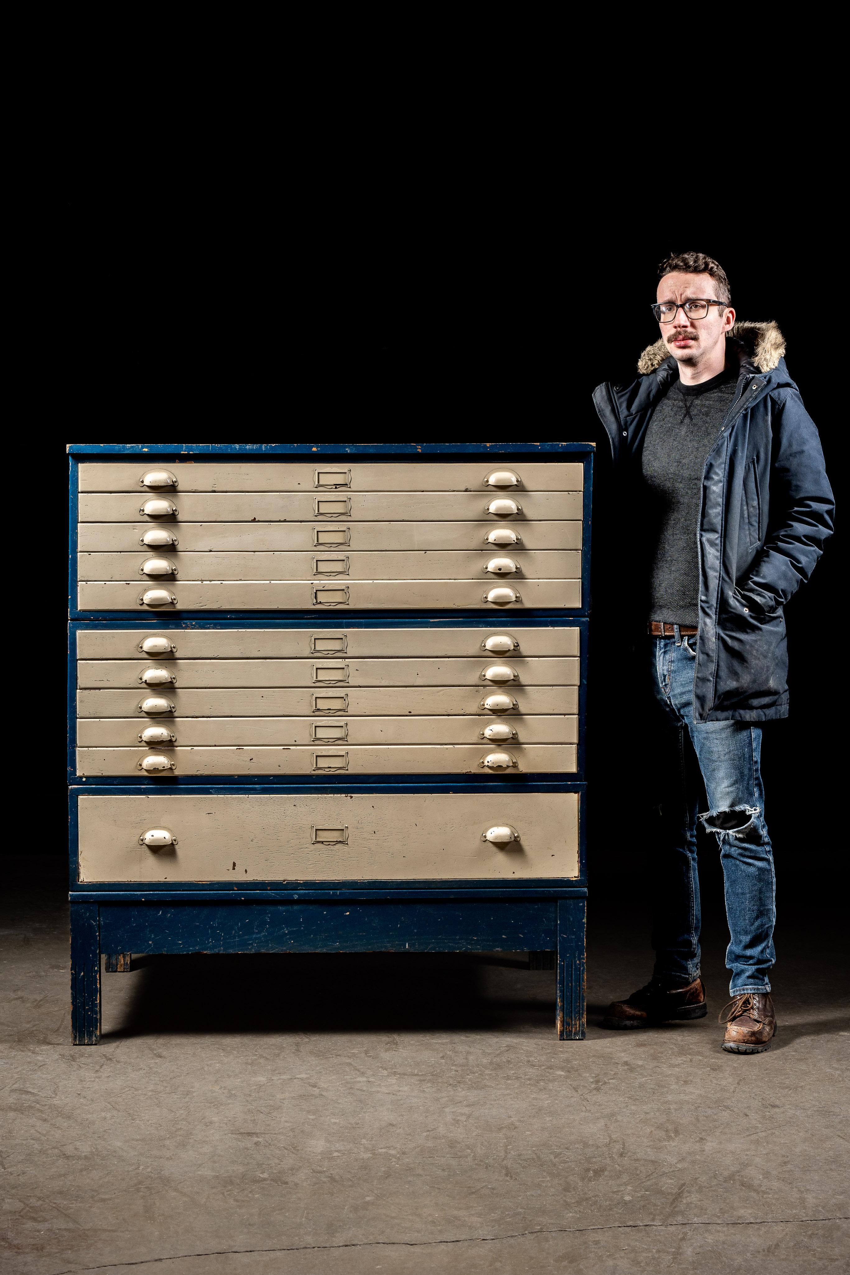 Large, antique flat file.

This piece features two stacks of 5-drawer cabinets plus a third comprised of a single drawer. While the cabinet has been painted blue, with white drawers, the original finished oak still shows through. Each drawer