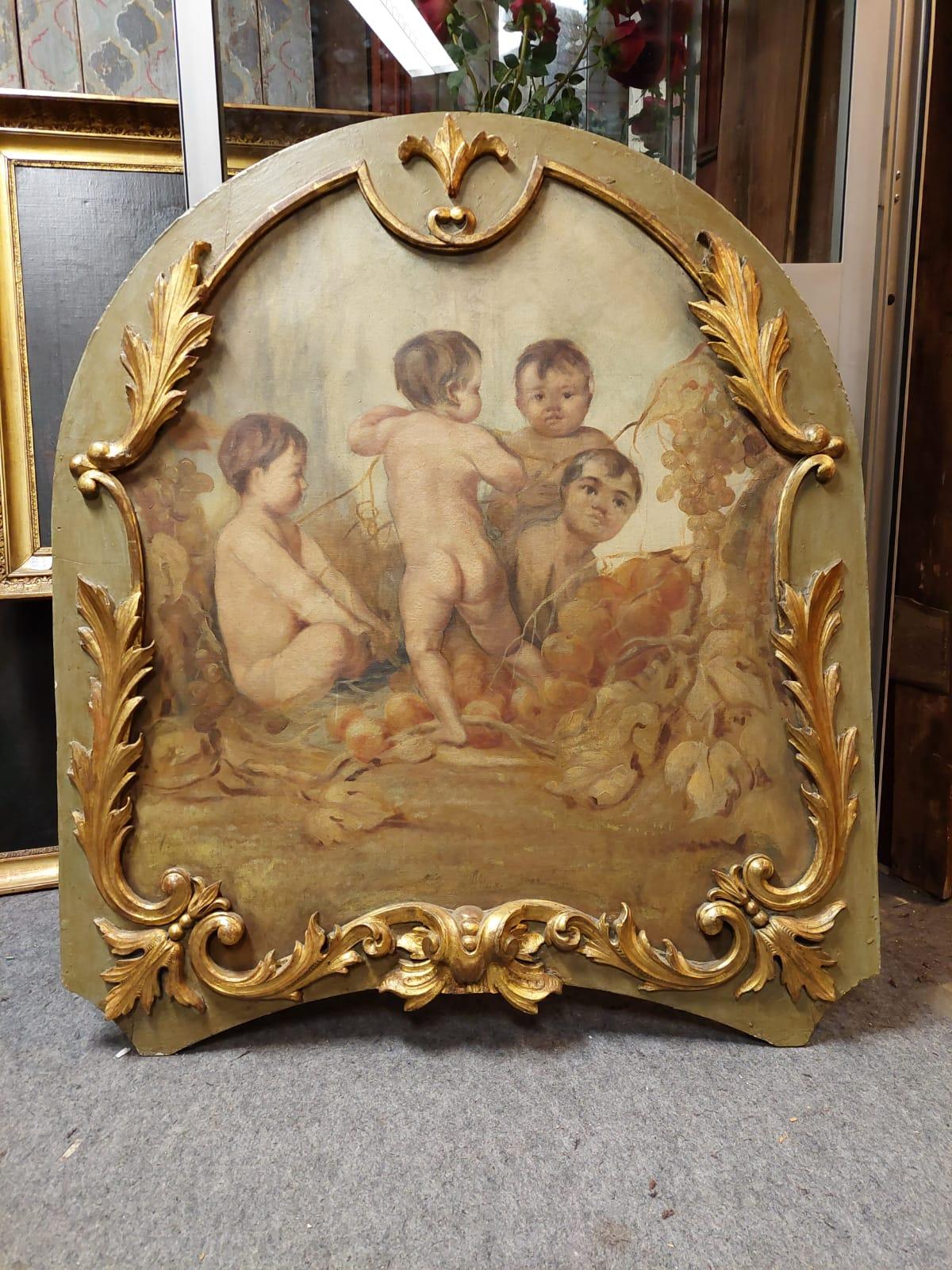 Ancient painted panel, painted with cherubs in oil on canvas, and carved frame with gilded molure, built in Italy (Piedmont) in the middle of the 18th century, has a green and gold relacquered frame and canvas in good state of conservation, with a