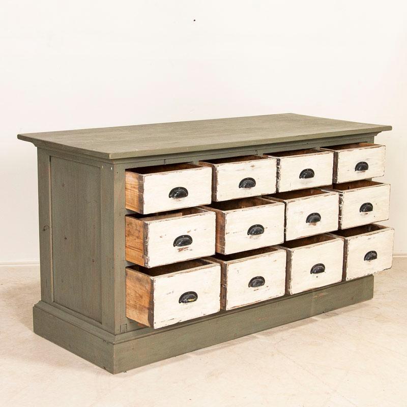 Fun and function combine in this free standing pine kitchen island with 12 drawers. This delightful pine cabinet originally served as a grocer's shop counter or storage cabinet. Counters similar to this were used throughout shops in the European