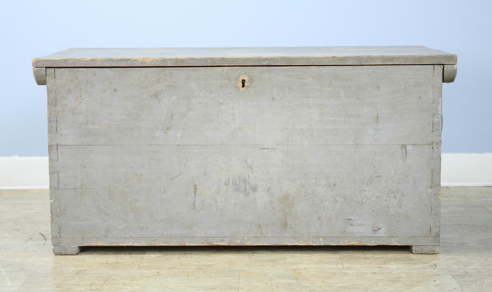 A great old blanket chest, probably used for storage at sea, with the original thick rope handles. Though the original paint is quite distressed the whole thing works, and is a great look for a country or seaside cottage. The interior has a little