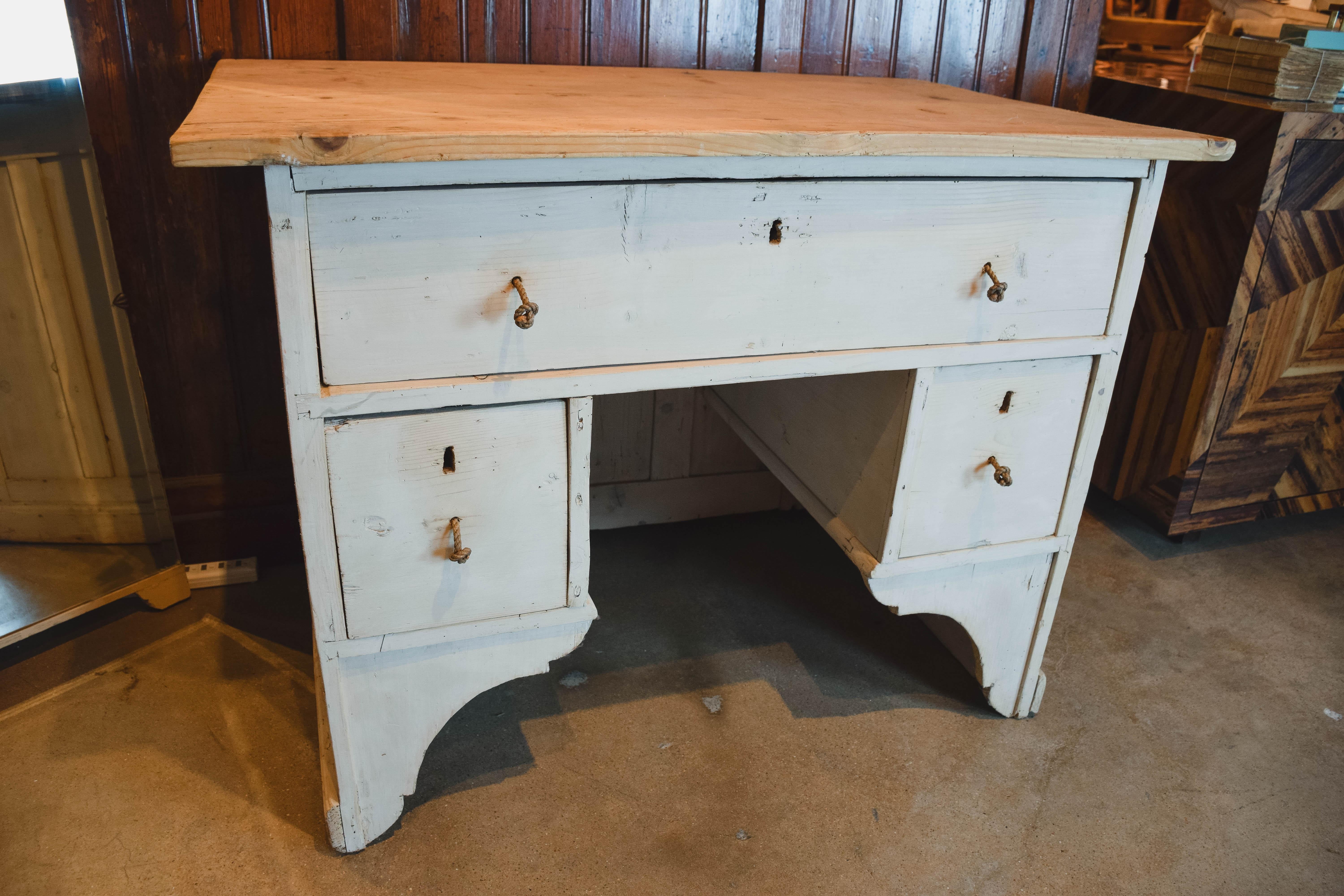 This wonderful antique shop counter/desk has a light three plank pine top and an antique painted finish on the bottom. The counter, finished on all sides has one long drawer, divided into two compartments on the inside that spans the width of the