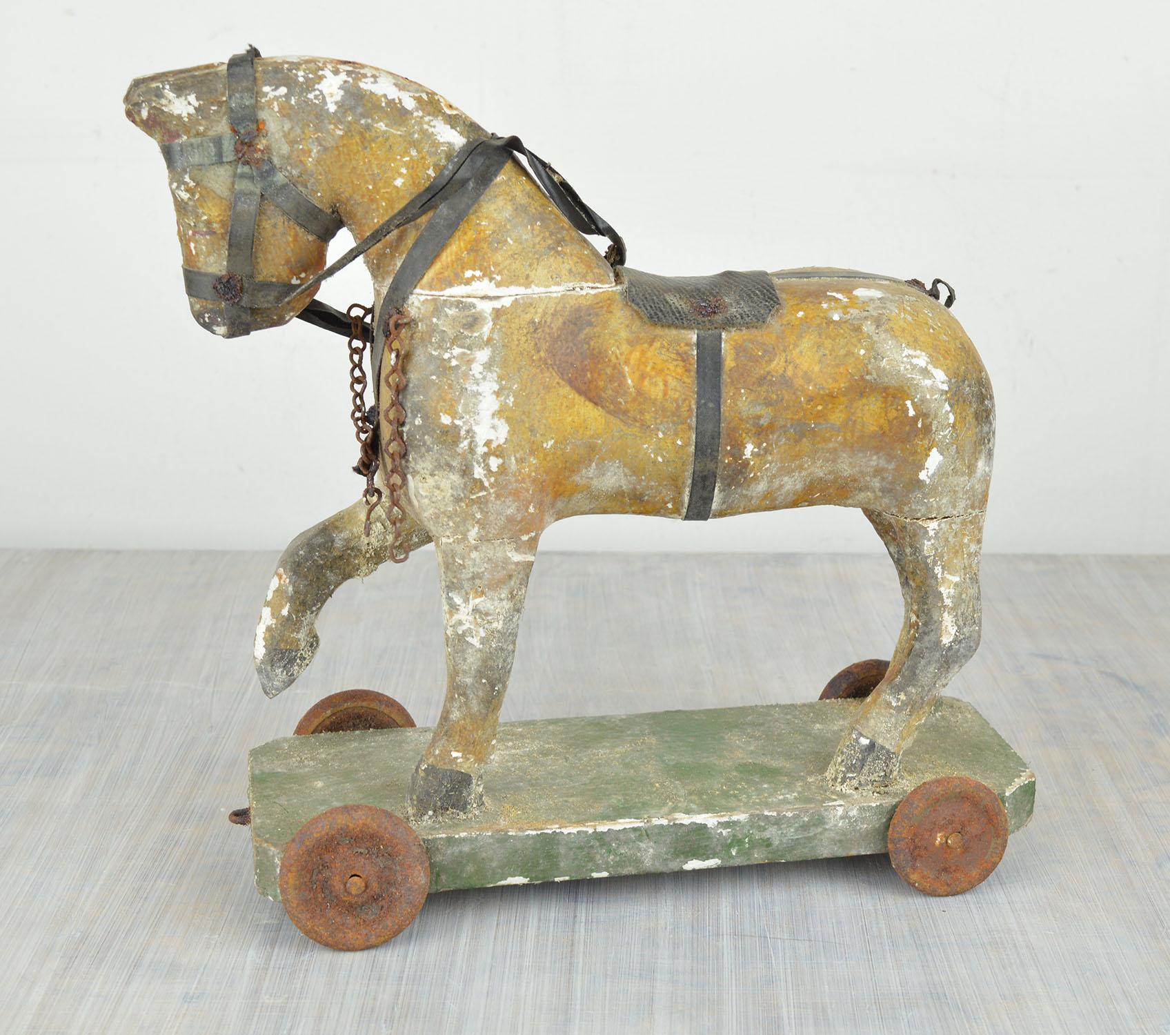 Charming little painted wood toy horse.

Distressed to perfection.

It has been a pull along toy.

Original paint. Original rusty metal wheels.

No restoration.