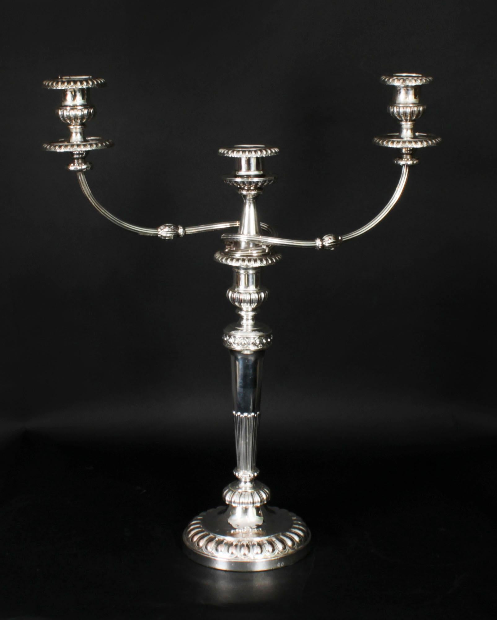 This is a stunning monumental pair of antique English Old Sheffield silver on copper, three light, two-branch table candelabra, circa 1790 in date, and bearing the sunburst makers marks of the world renowned silversmith Matthew Boulton.

The