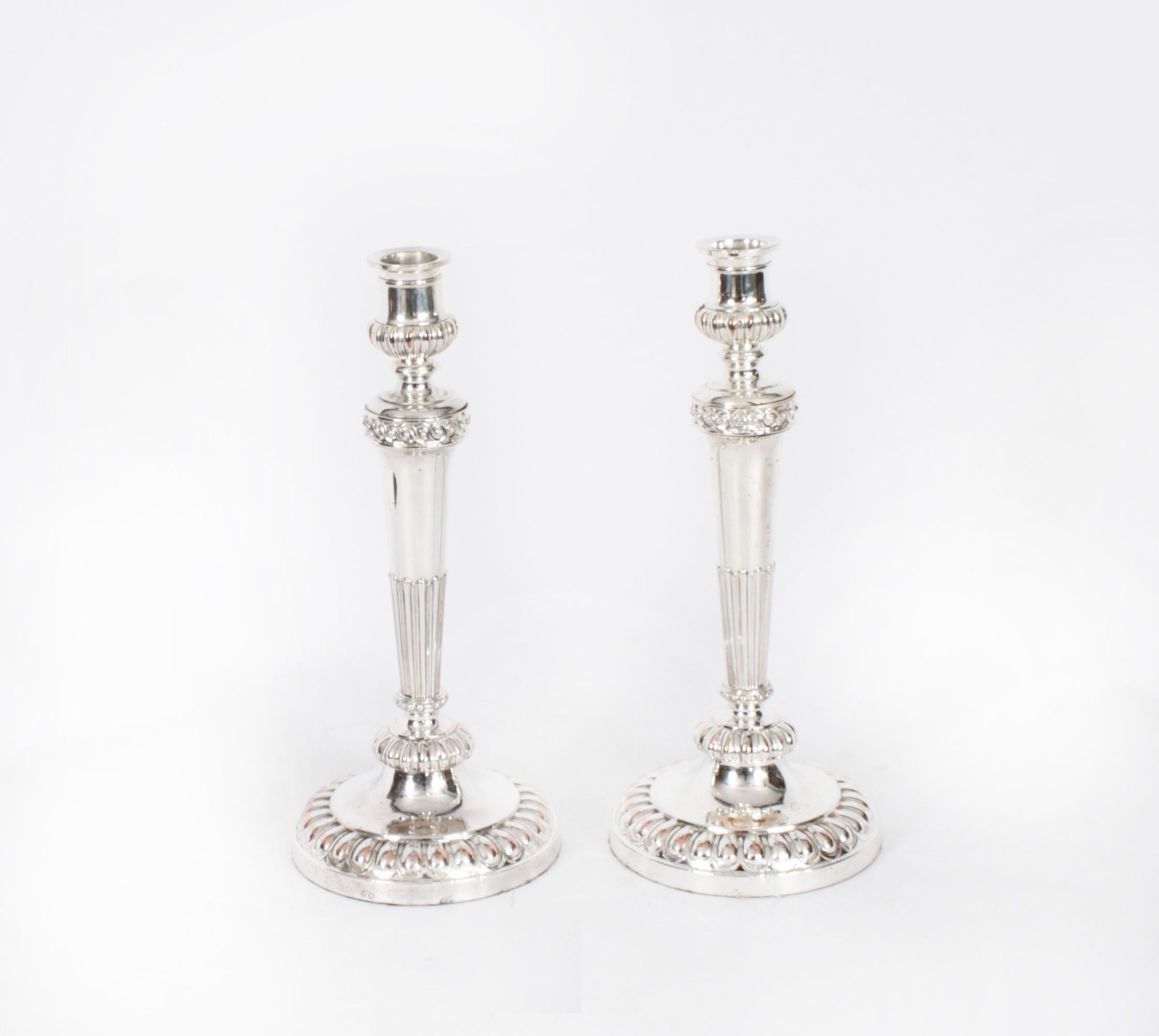 This is a stunning monumental pair of antique English Old Sheffield silver on copper, three light, two-branch table candelabra, circa 1790 in date, and bearing the sunburst makers marks of the world renowned silversmith Matthew Boulton.

The
