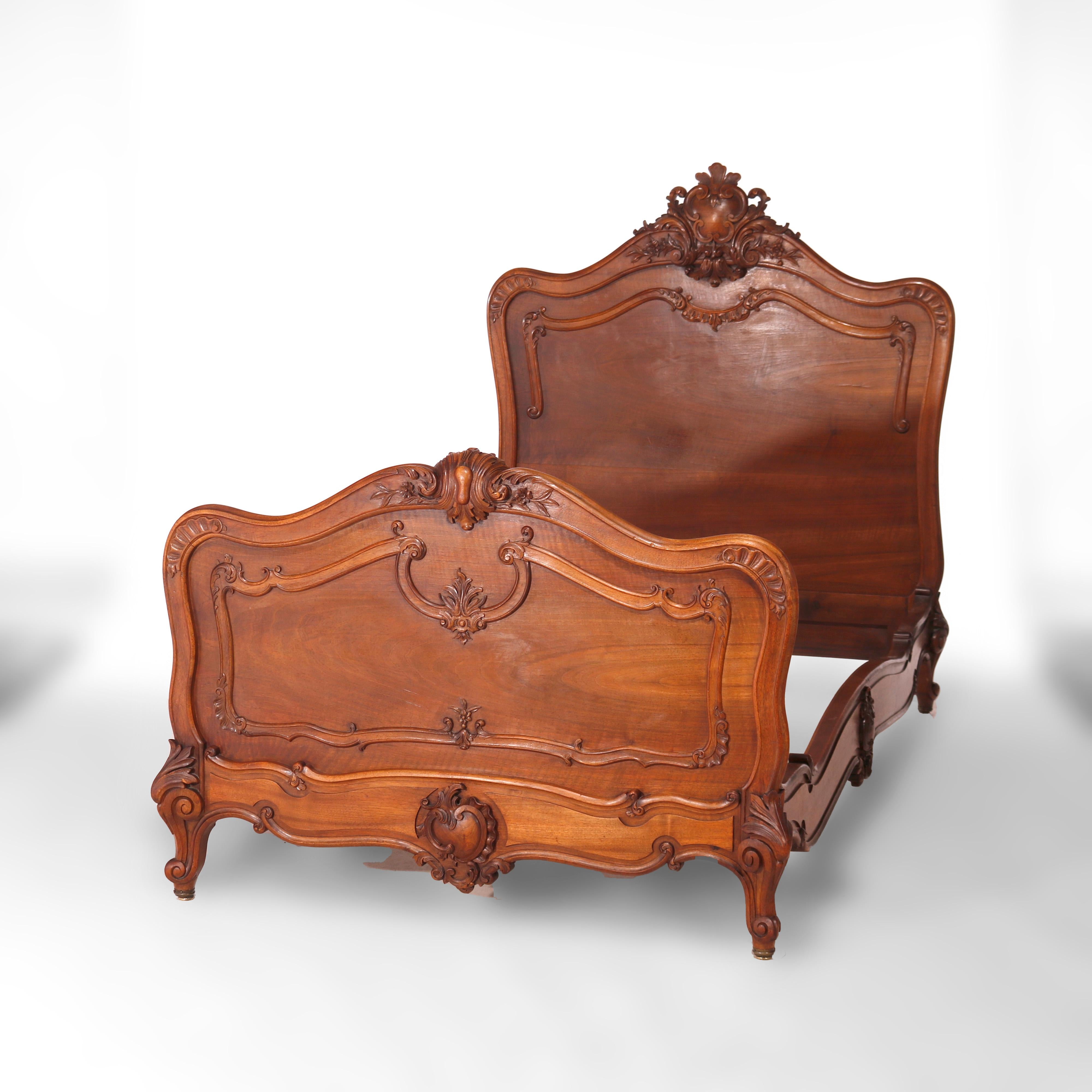 An antique pair of French Rococo twin beds offers mahogany construction with shaped headboard having carved foliate crest, matching footboard, raised on cabriole legs terminating in scroll form feet, 19th century

Measures - headboard 54