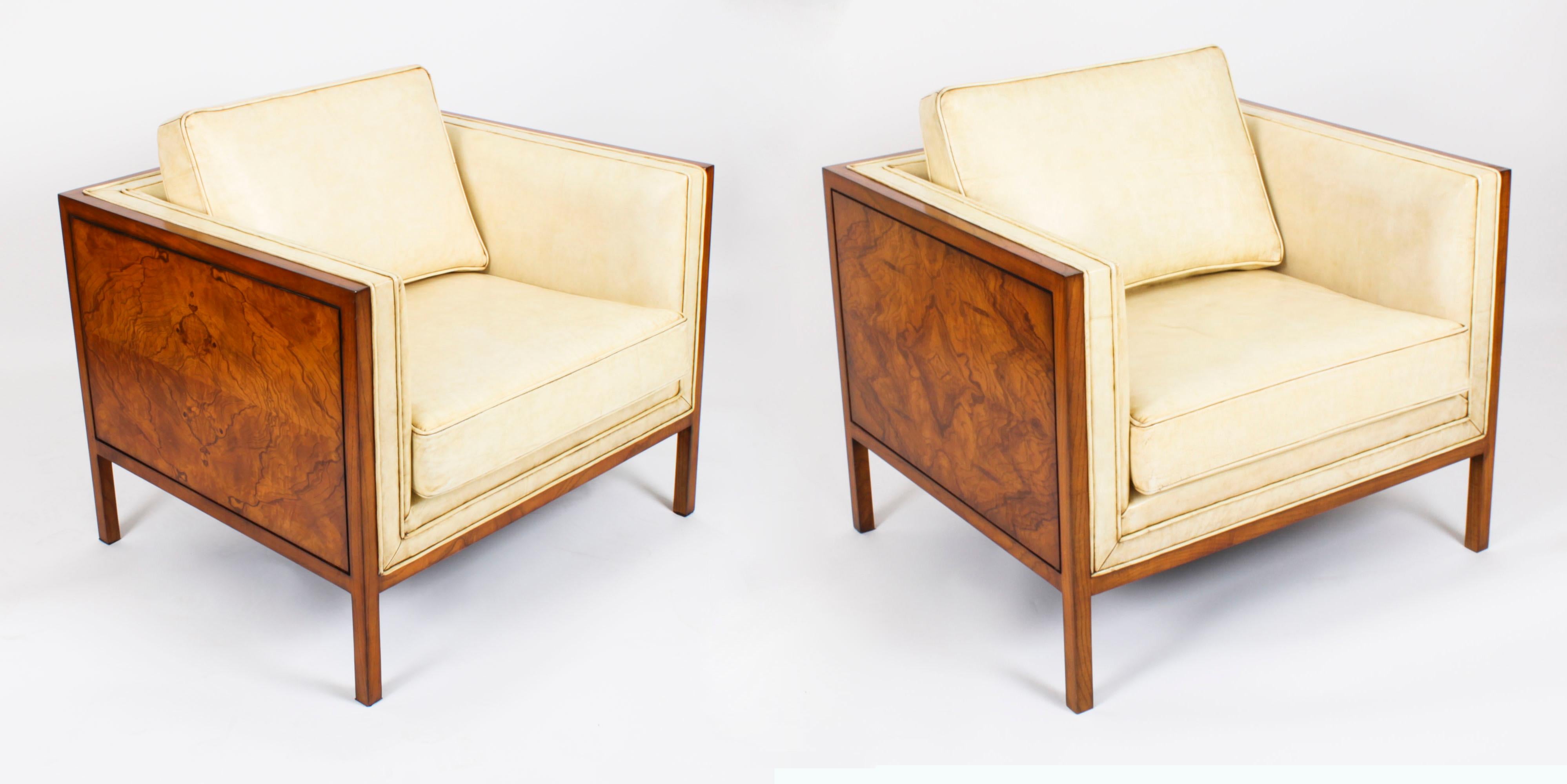 This is a stylish antique pair of Art Deco armchairs in burr walnut and walnut that have been upholstered in a luxurious cream leather with cream leather piping, circa 1920 in date

This very comfortable pair of armchairs feature decorative burr
