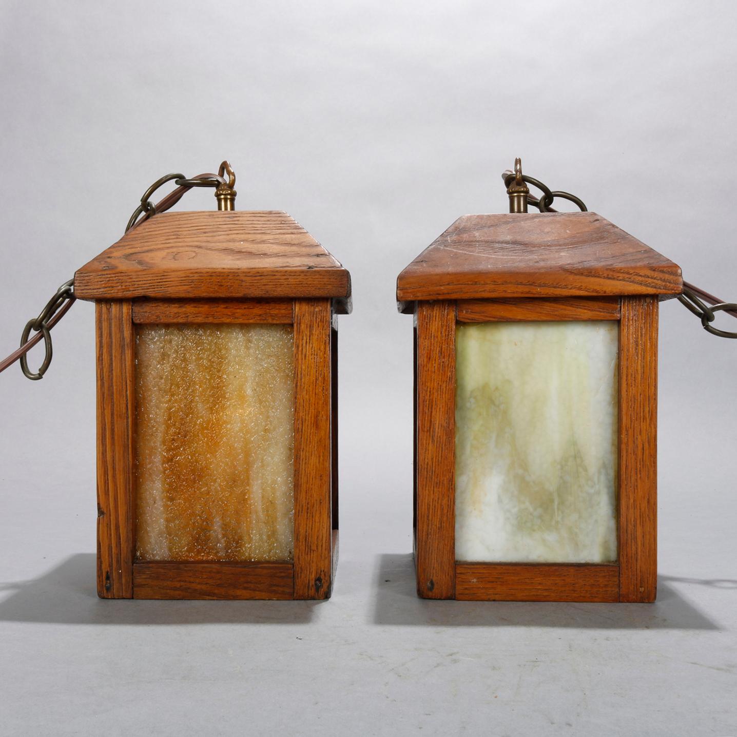 Carved Pair of Arts & Crafts Mission Oak and Slag Glass Hanging Lanterns, circa 1910