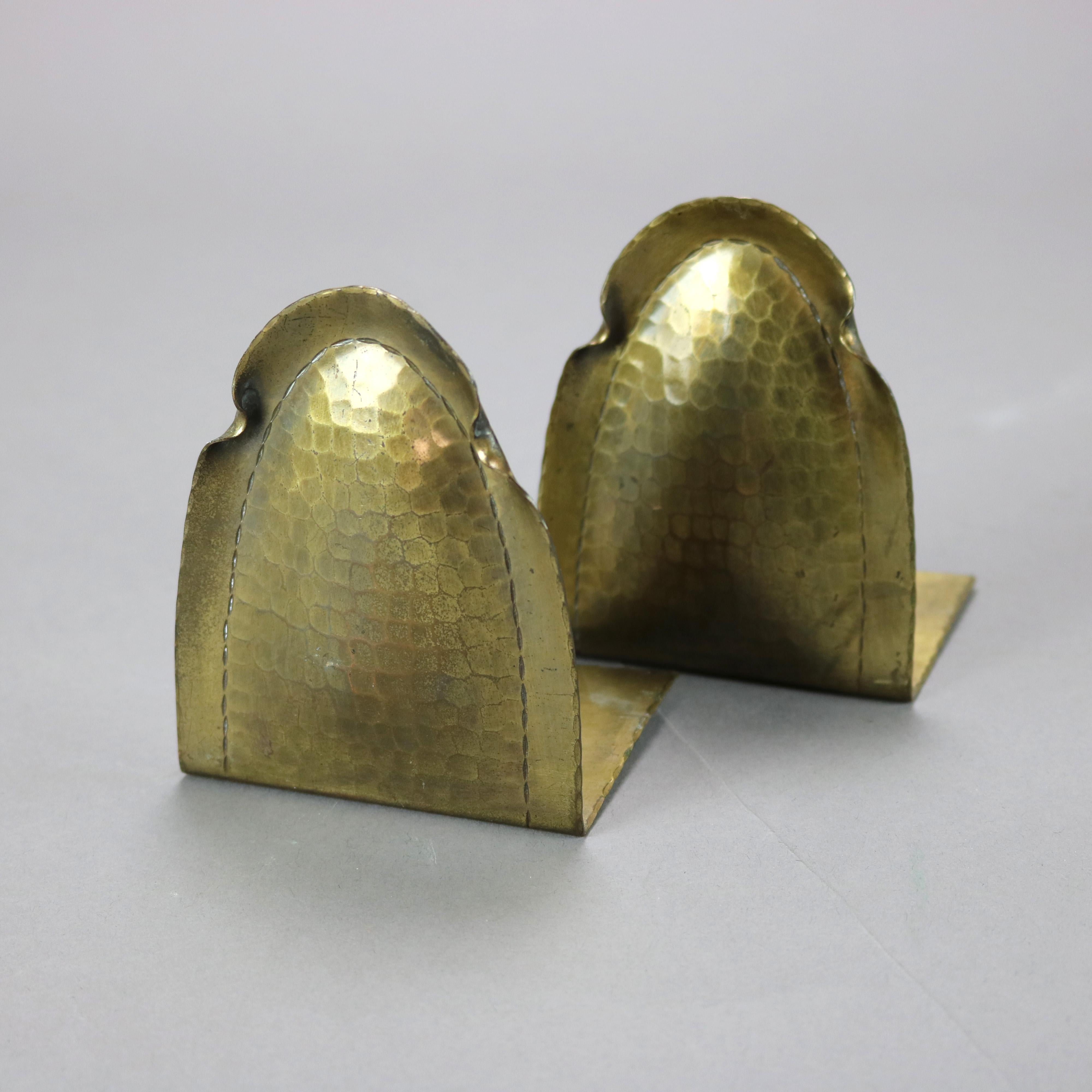 An antique pair of Arts & Crafts bookends by Roycroft offer brass over hammered copper construction in stylized dome form, stamped on base as photographed, c1910

Measures - 4''h x 3.25''w x 2.5''d.