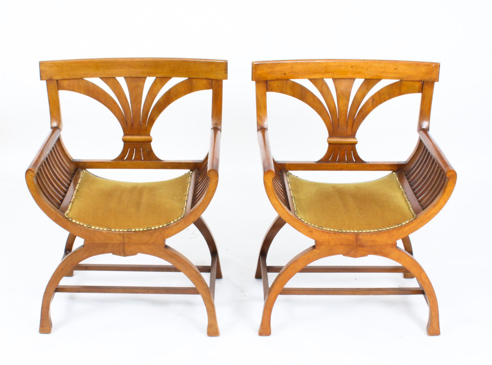This is a elegant Antique pair of Austrian Biedermeier Walnut 'X' frame armchairs, circa 1830 in date.
 
The chairs are after the model by Josef Danhauserwith and each features a rectangular top rail above open shaped feather splats with scrolled