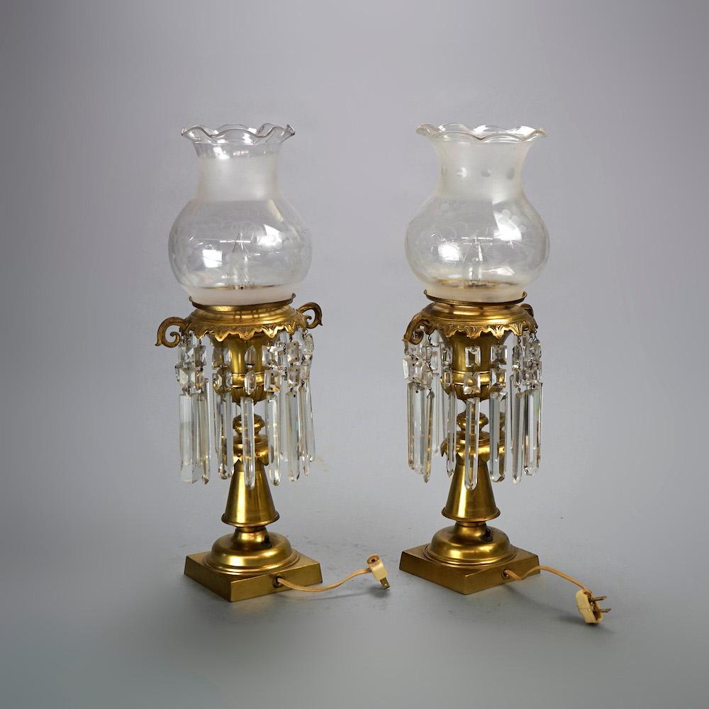 An antique pair of solar astral lamps offer cast brass balustrade columns with double foliate handles and grape and vine etched glass shades, electrified, c1850.

Measures- 19.5''H x 7.75''W x 6''D.