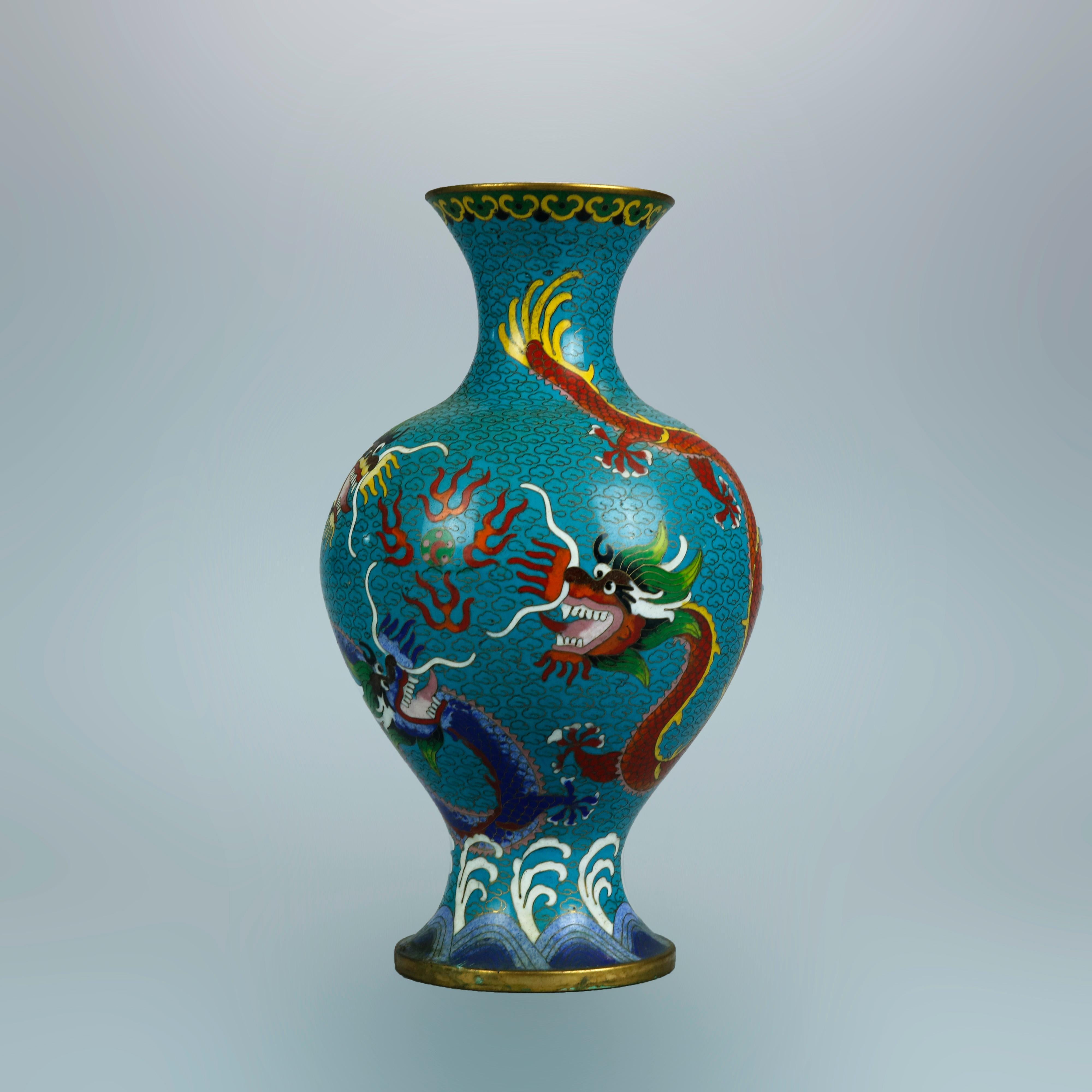 An antique pair of Chinese Meiji vases offer Cloisonne enameled design with dragons, c1900

Measures: 10.25