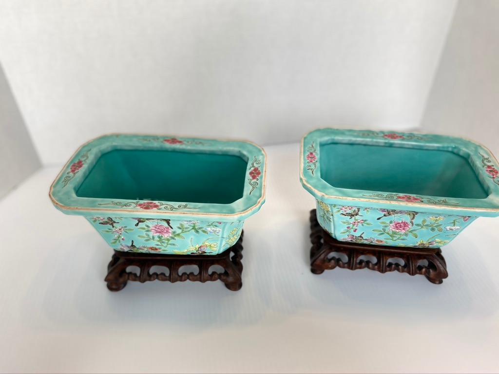 Pair of antique Chinese porcelain jardinières
Turquoise ground rectangle shape. Tapering sides. Hand painted floral design on hand made wooden stands that match.
19th century.