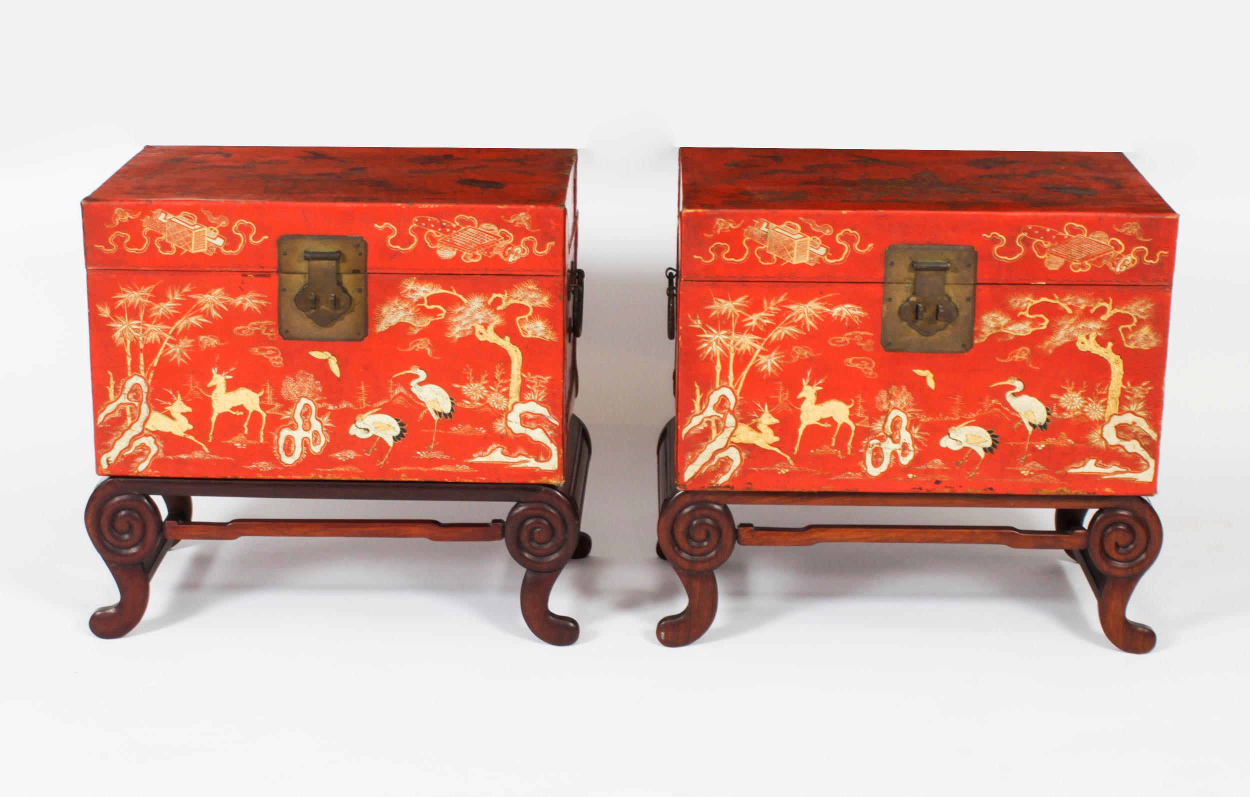 This is a stunningly beautiful antique pair of Chinese red lacquered leather chinoiserie  trunks, circa 1880 in date.

The pair features rectangular shaped red leather trunks decorated with gilt herons and deer amongst trees and butterflies in an