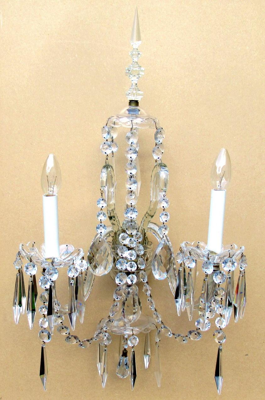 Stunning example of an exceptional pair of English full lead handcut crystal twin light electric wall sconces of large proportions, first half of the 19th century.

Firmly attributed to F & C Osler. 

Each with twin out swept facet-cut arms and