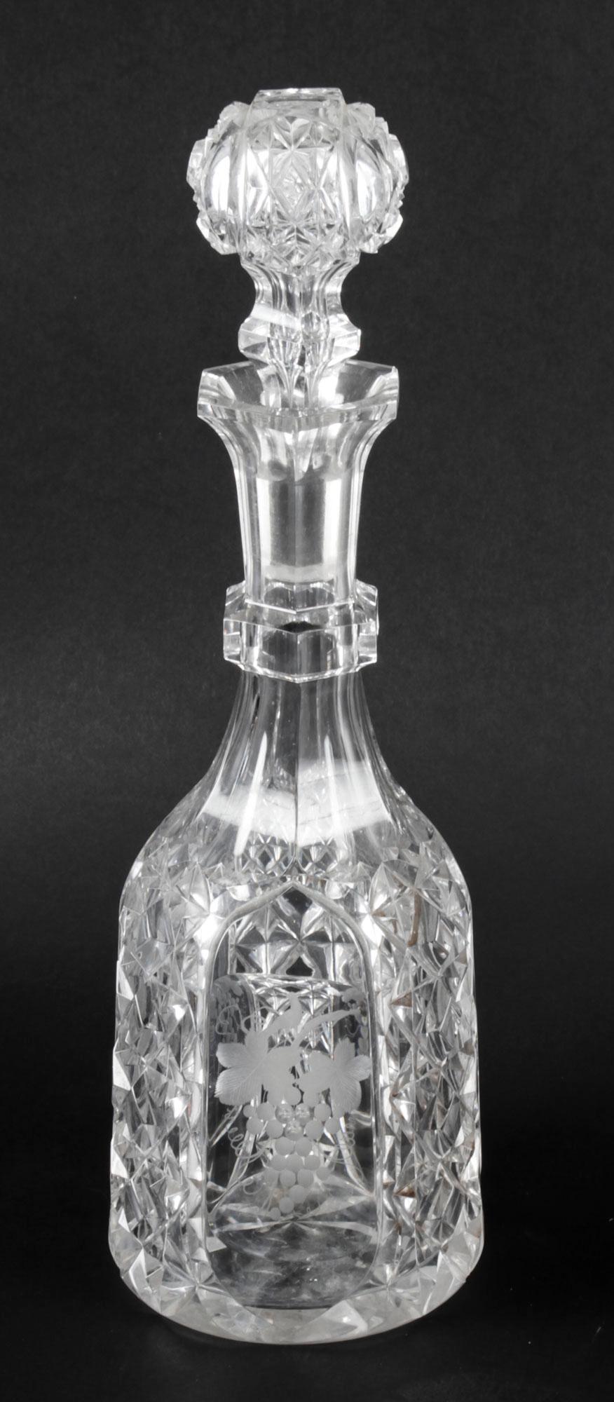 A superb pair of antique cut glass wine decanters and stoppers having etched grapes to the panelled sides and Circa 1870 in date.

This lovely pair can serve decorative as well as practical purposes.

Add a touch of class to your next dining